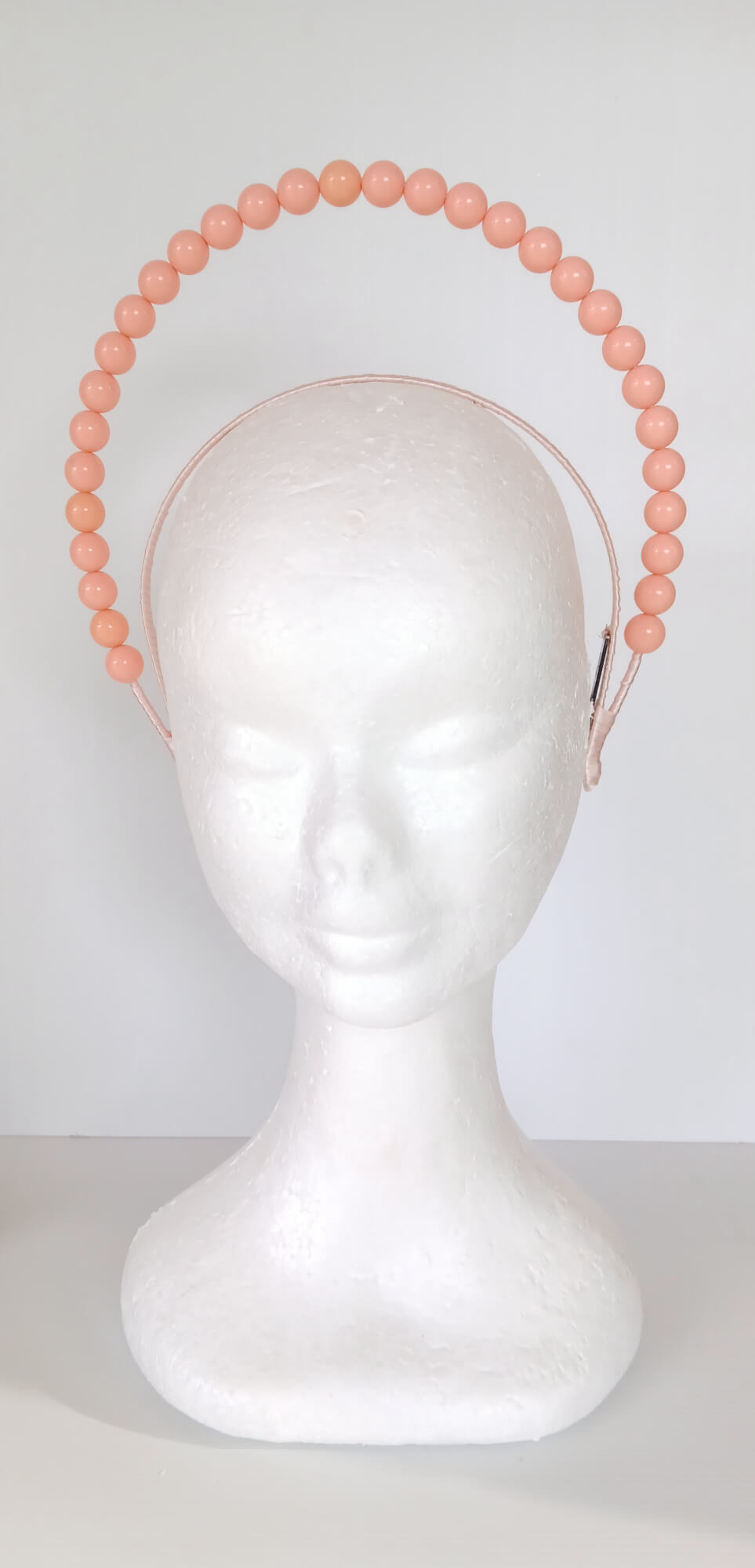 A picture of an Apricot Beaded Headband by Melissa Rath Millinery.