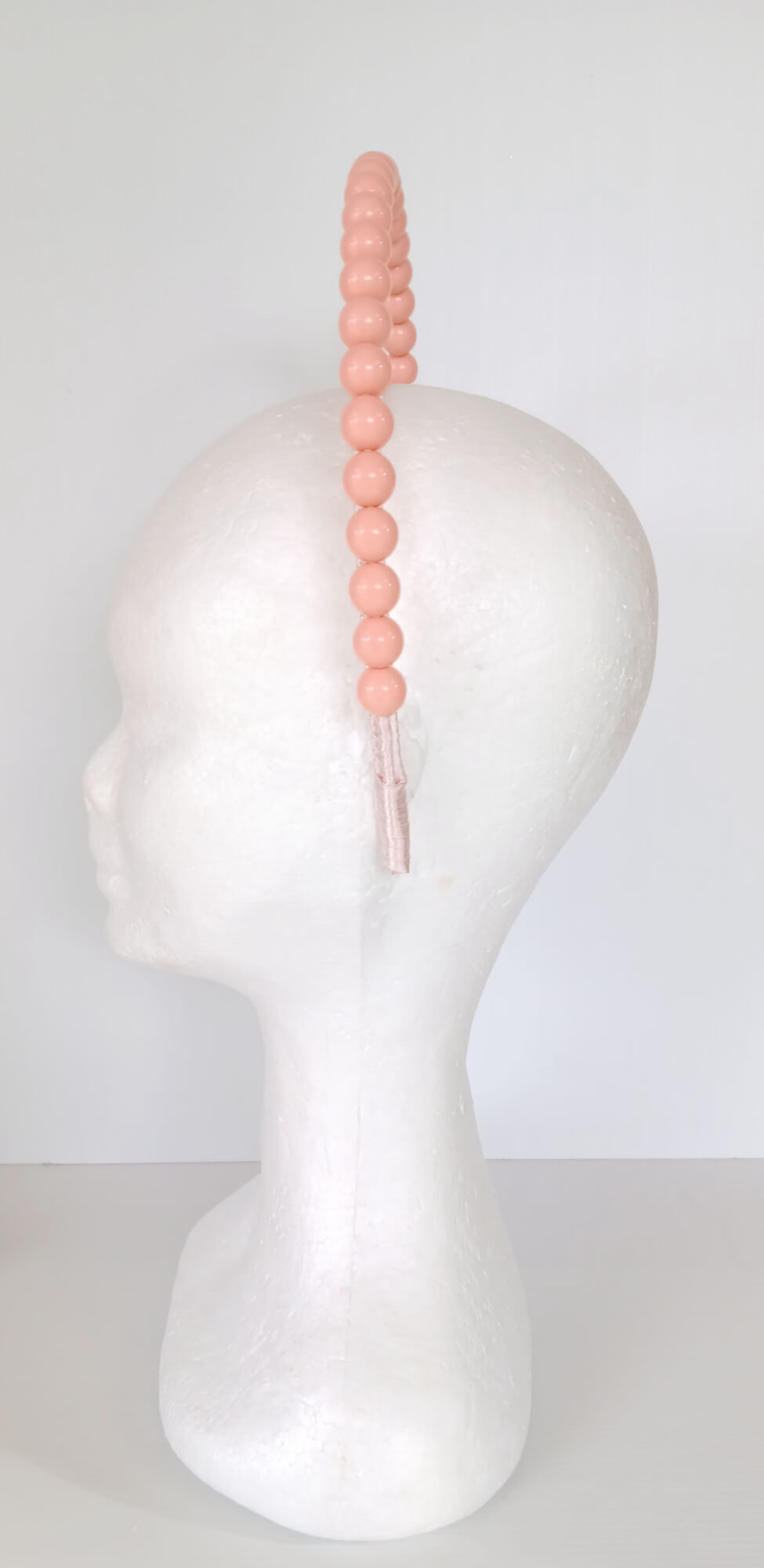 A picture of an Apricot Beaded Headband by Melissa Rath Millinery.