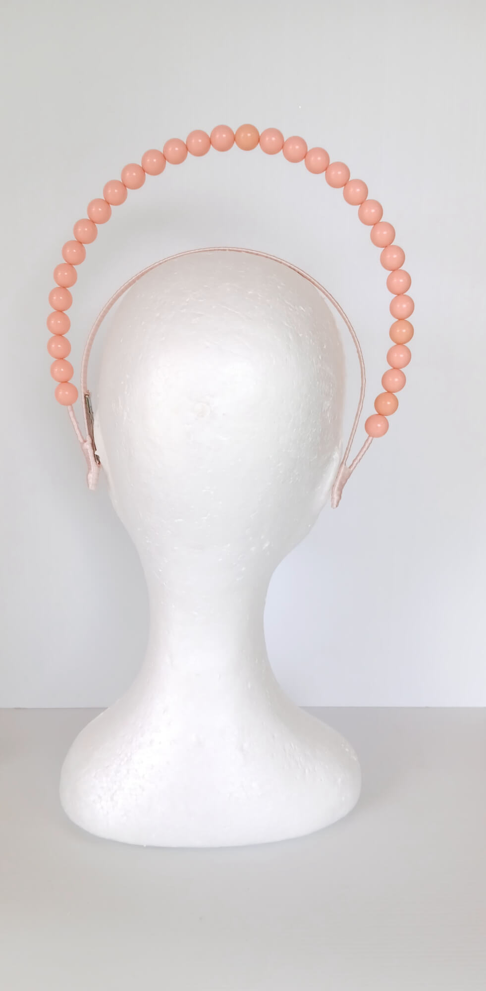 A picture of an Apricot Beaded Headband by Melissa Rath Millinery.