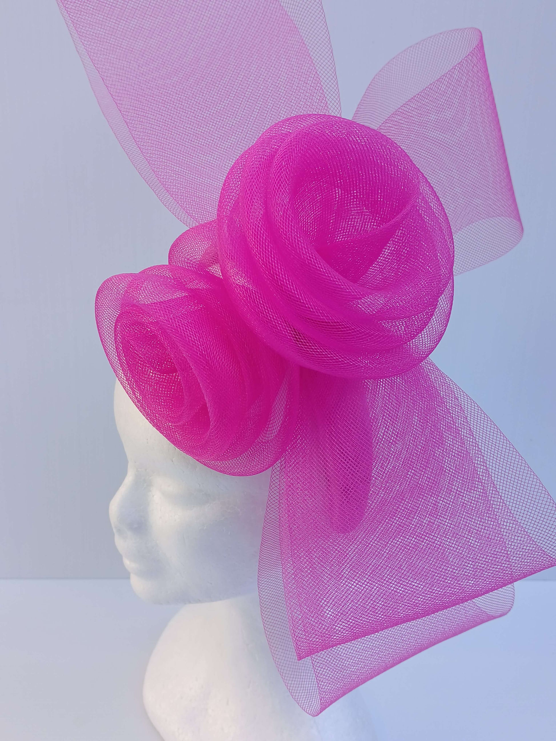 A picture of a Pink Crinoline Bow and Rose Headband by Melissa Rath Millinery