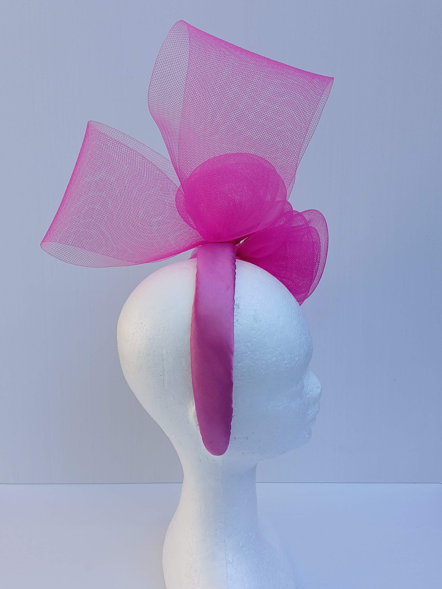 A picture of a Pink Crinoline Bow and Rose Headband by Melissa Rath Millinery