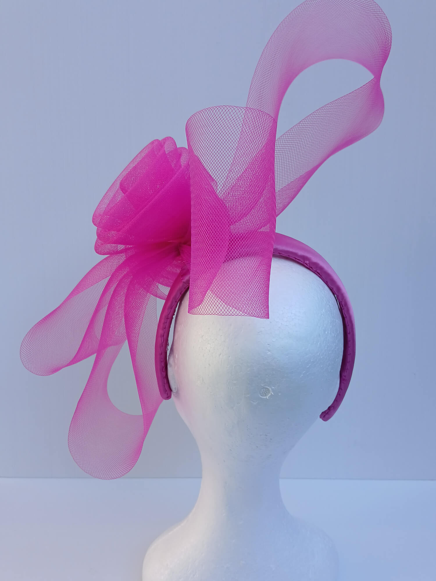 An image of a Pink Crinoline Bow and Rose Millinery Headband by Melissa Rath Millinery.