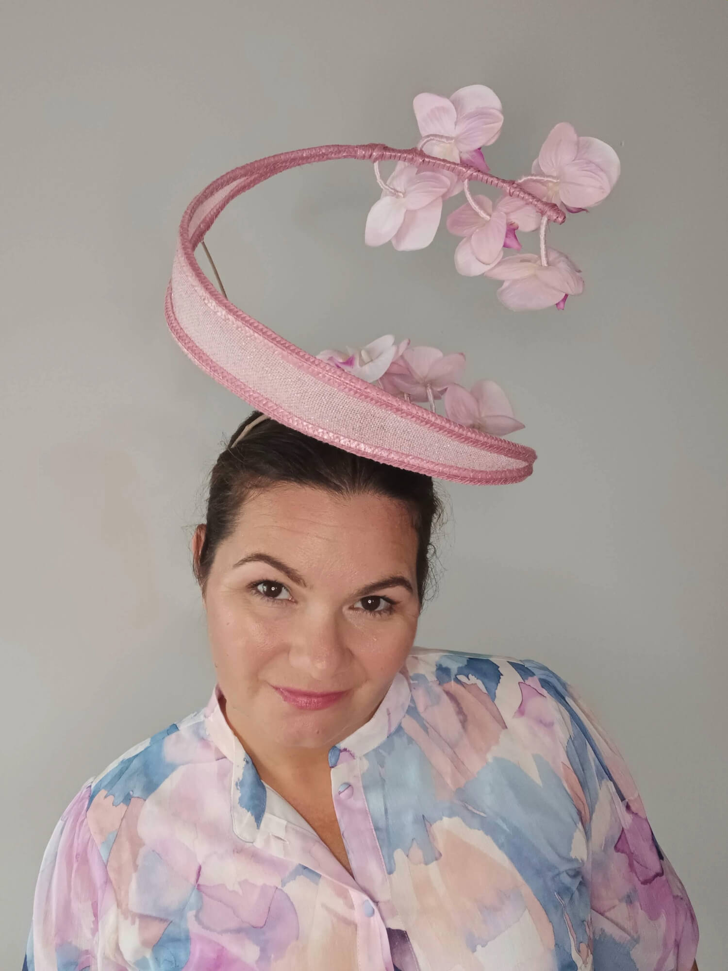 A picture of a Pink Orchid Floating Headpiece by Melissa Rath Millinery