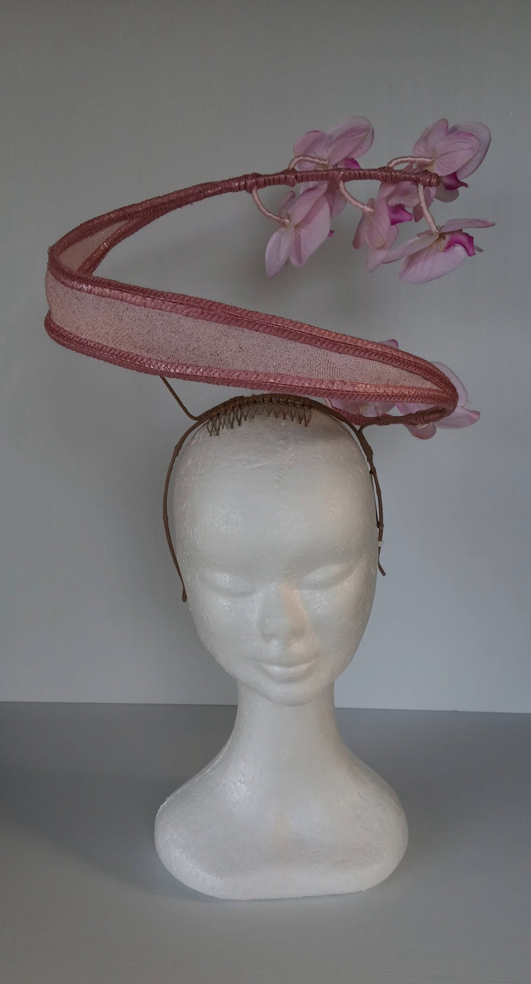 A picture of a Pink Orchid Floating Headpiece by Melissa Rath Millinery