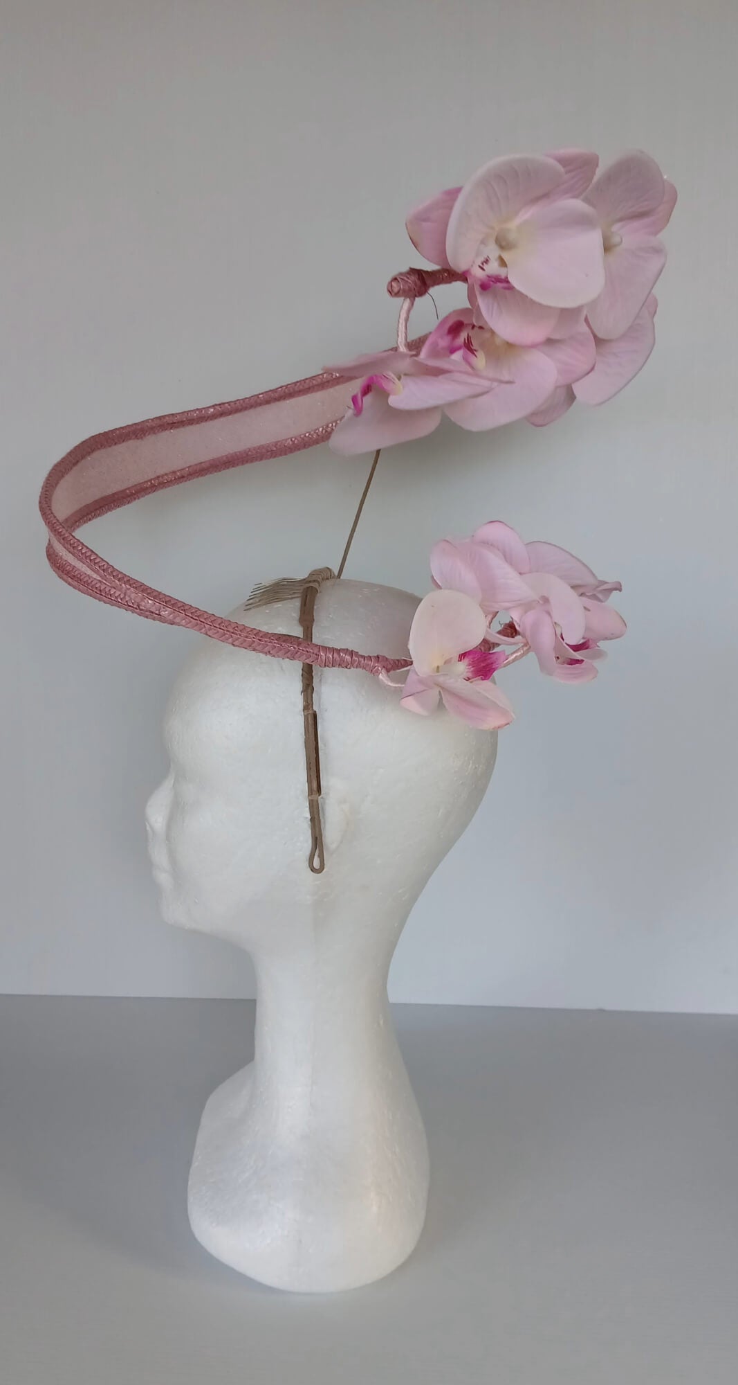A picture of a Pink Orchid Floating Headpiece by Melissa Rath Millinery