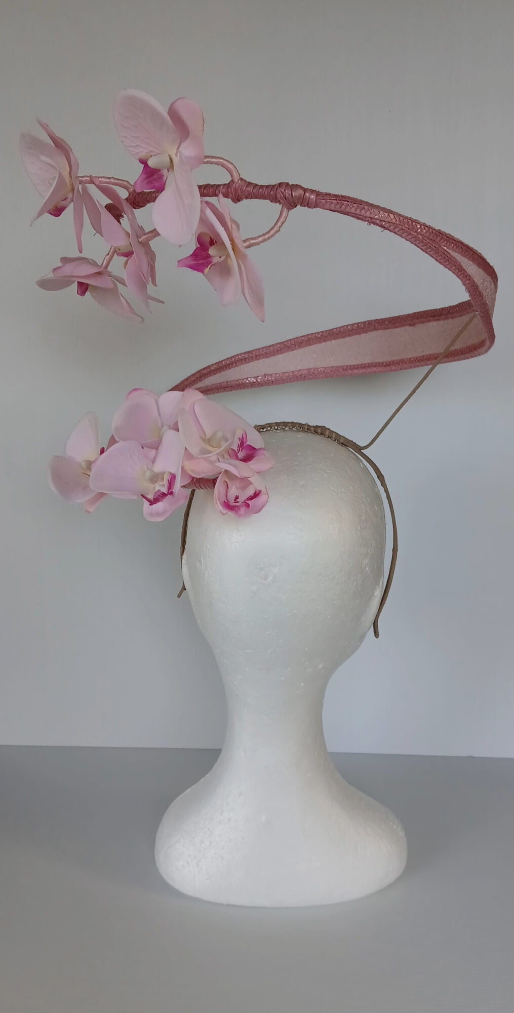 A picture of a Pink Orchid Floating Headpiece by Melissa Rath Millinery