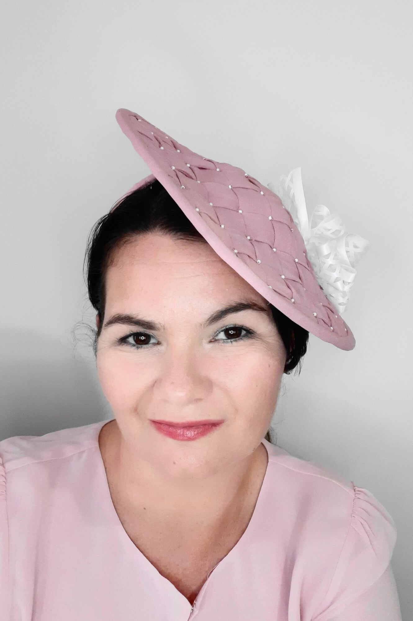 A picture of a Pink and White Saucer Hat by Melissa Rath Millinery.