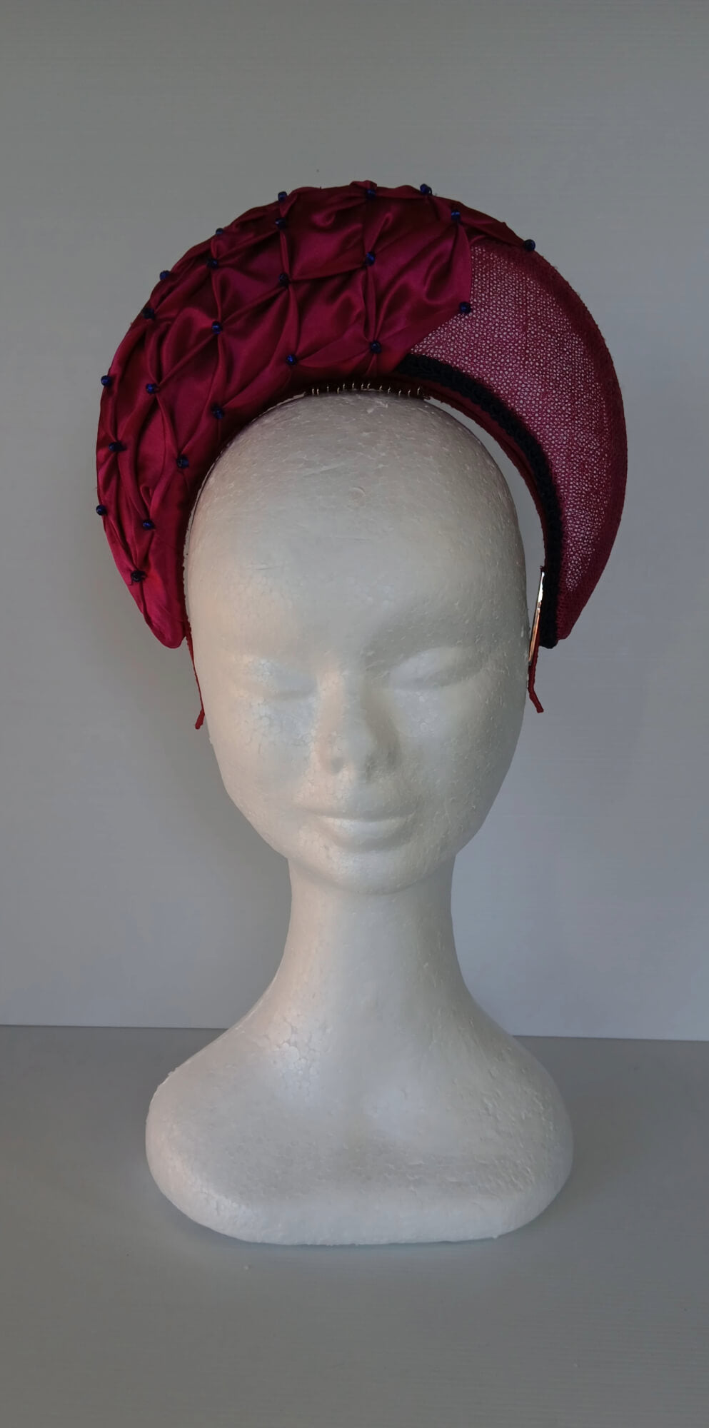 A picture of a Pink Smocked Millinery Crown by Melissa Rath Millinery. 