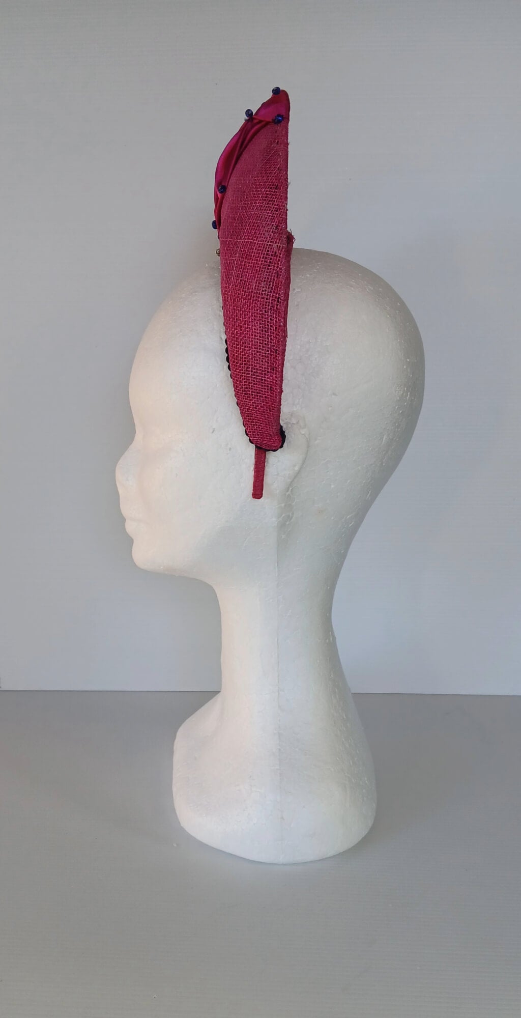 A picture of a Pink Smocked Millinery Crown by Melissa Rath Millinery. 