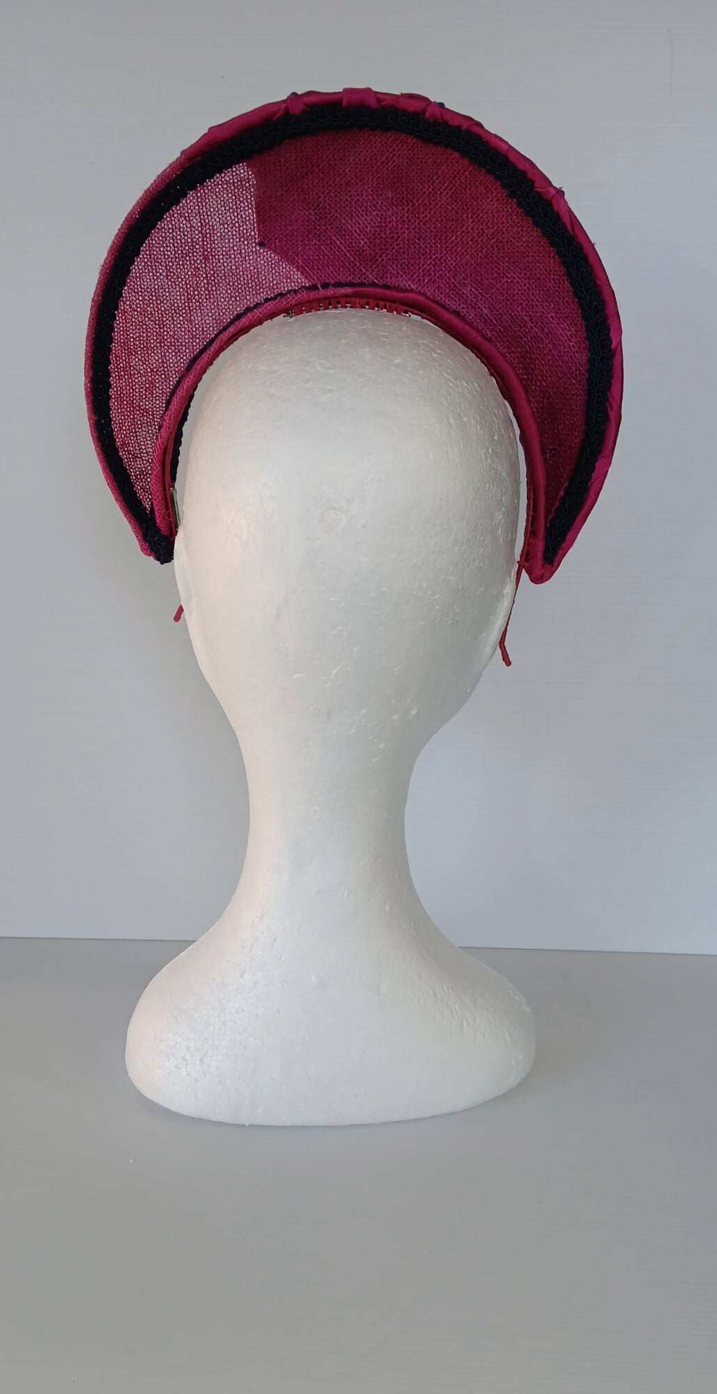 A picture of a Pink Smocked Millinery Crown by Melissa Rath Millinery. 