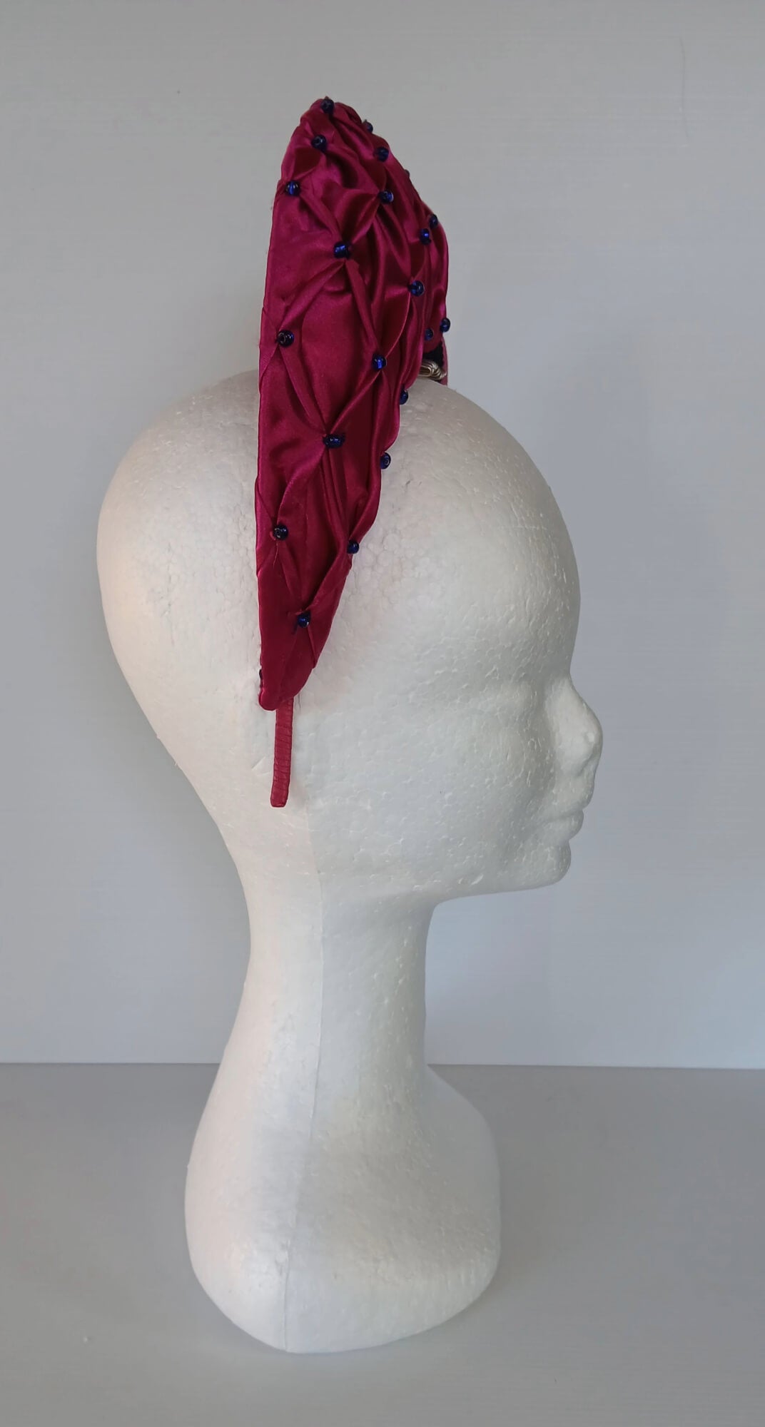 A picture of a Pink Smocked Millinery Crown by Melissa Rath Millinery. 
