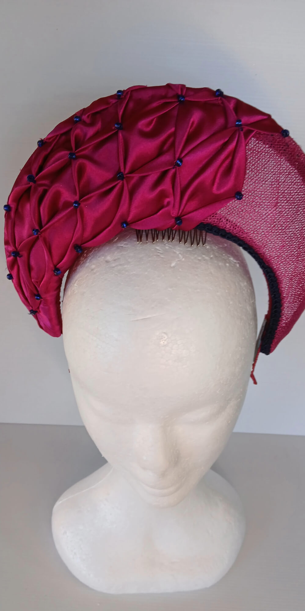A picture of a Pink Smocked Millinery Crown by Melissa Rath Millinery. 
