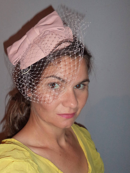 A picture of a Pink Veiled Leather Millinery Fascinator by Melissa Rath Millinery.