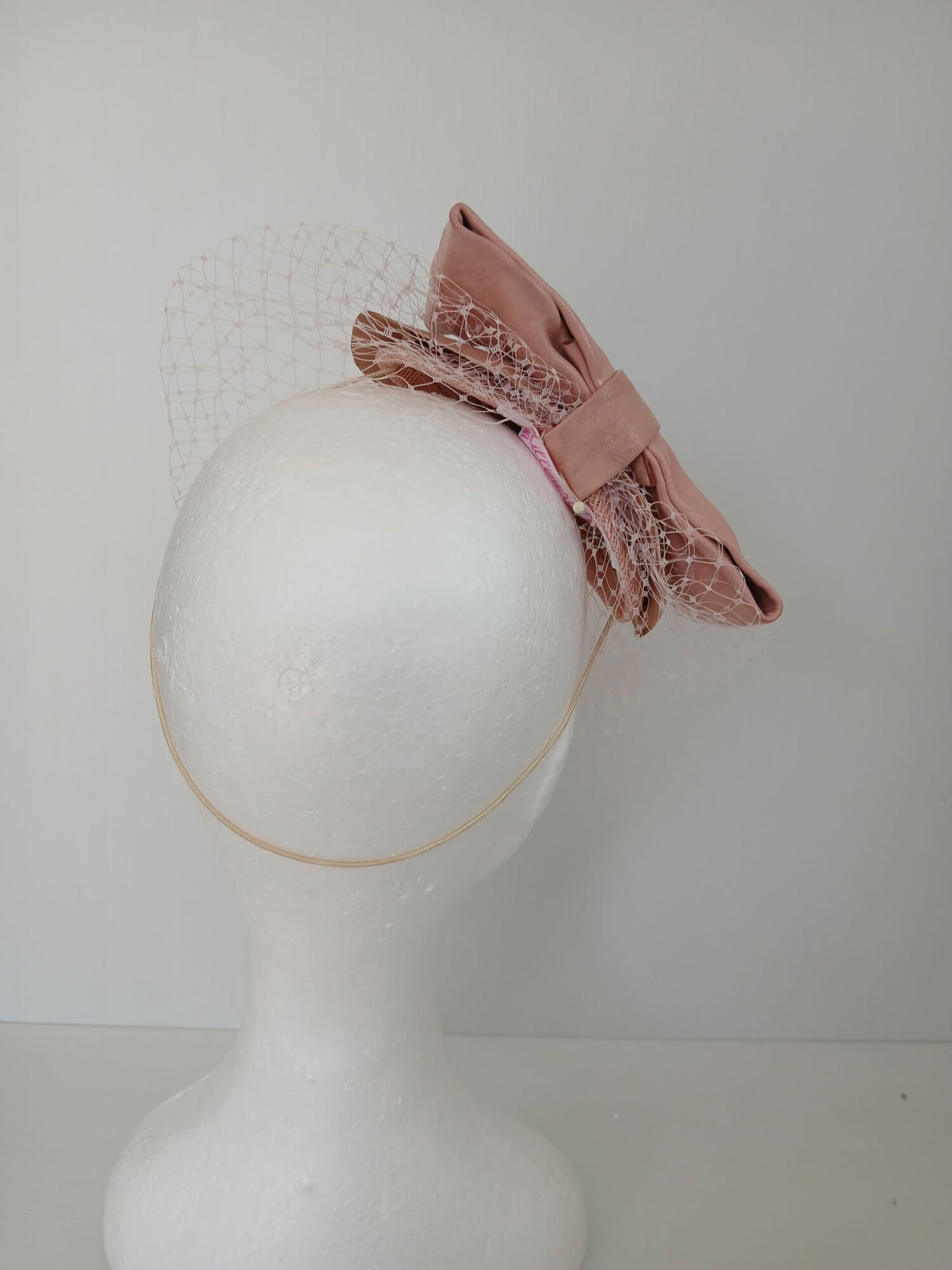 A picture of a Pink Veiled Leather Millinery Fascinator by Melissa Rath Millinery.