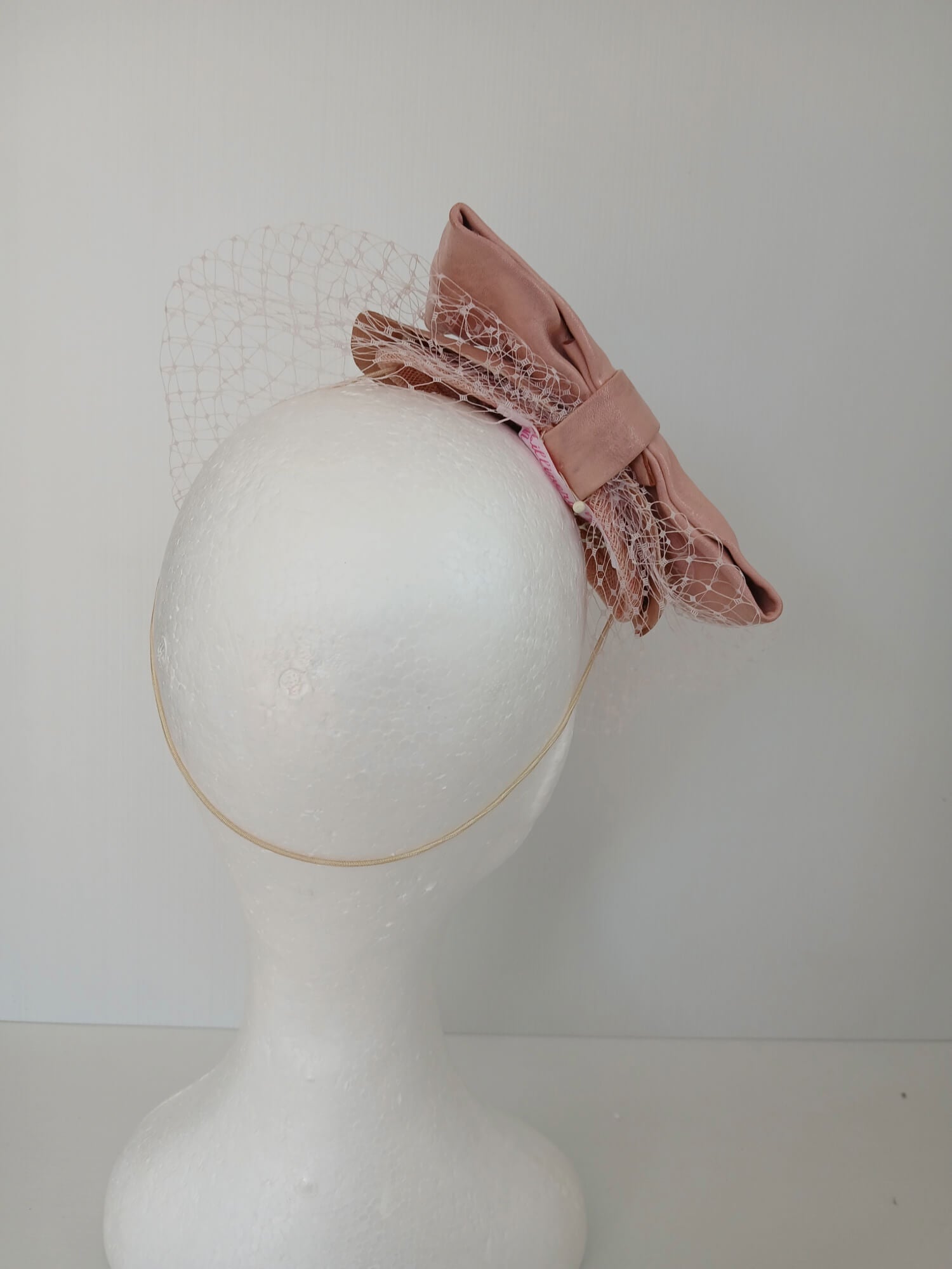 A picture of a Pink Veiled Leather Millinery Fascinator by Melissa Rath Millinery.
