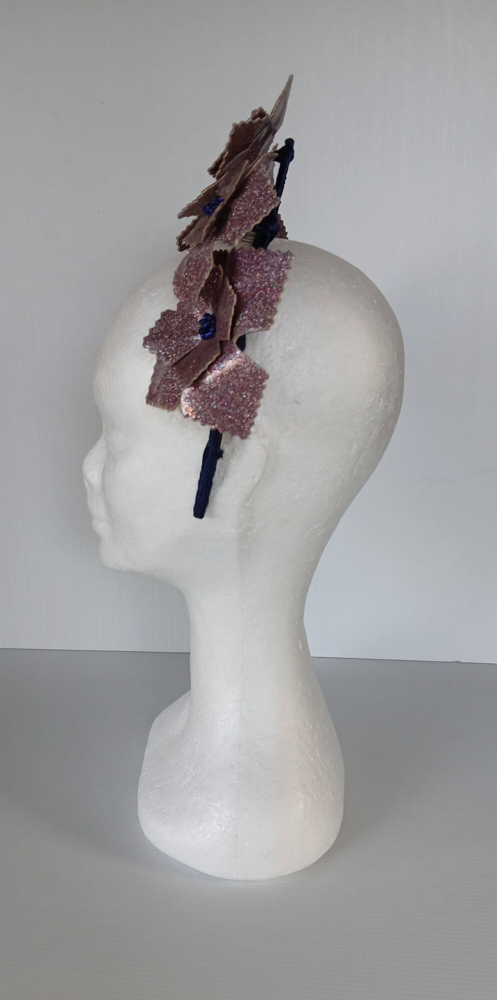 A picture of a pink and navy millinery crown.