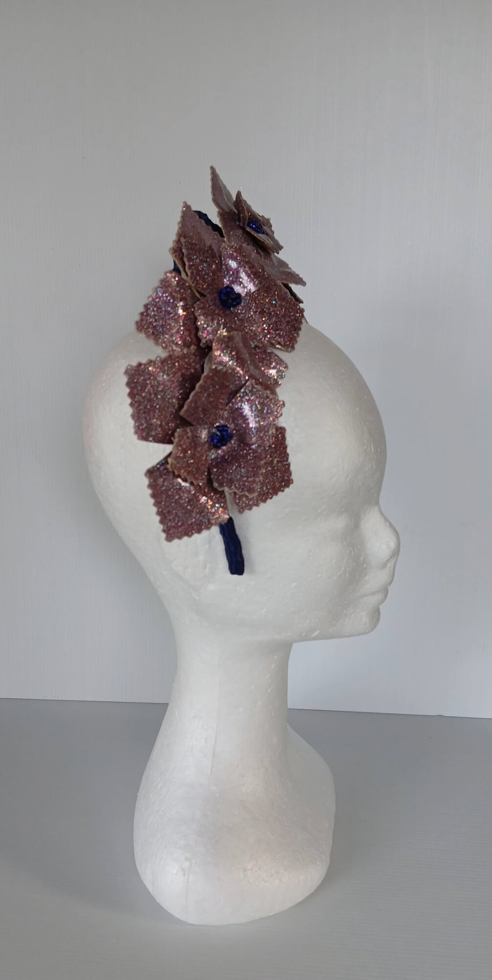 A picture of a pink and navy millinery crown.