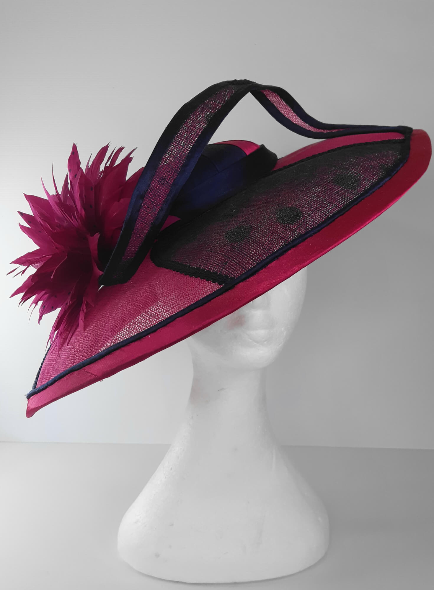 A picture of a Pink and Navy Wide Brimmed Hat by Melissa Rath Millinery.