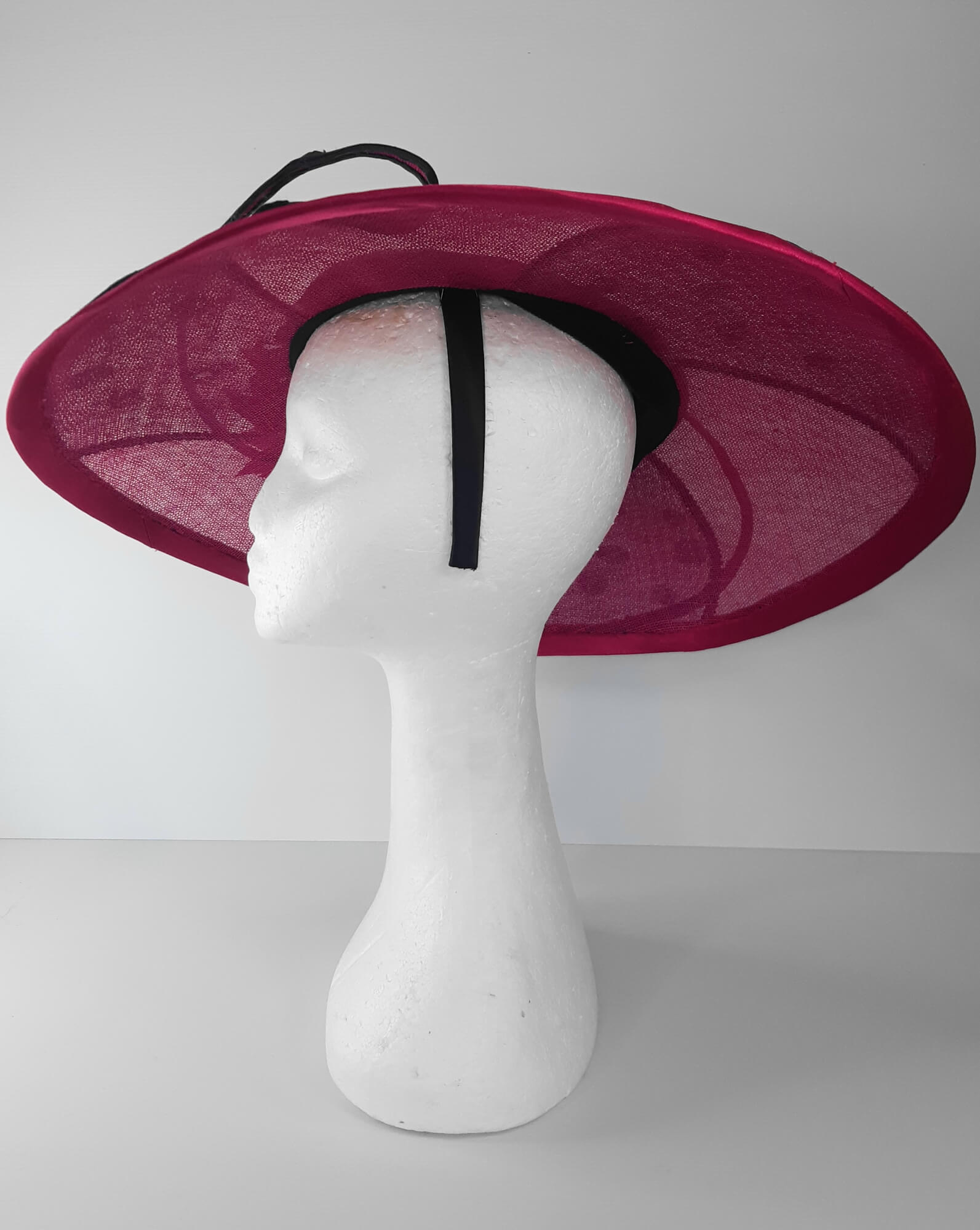 A picture of a Pink and Navy Wide Brimmed Hat by Melissa Rath Millinery.