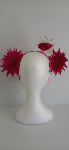 A picture of the pink and white feather flower headband by Melissa Rath Millinery.