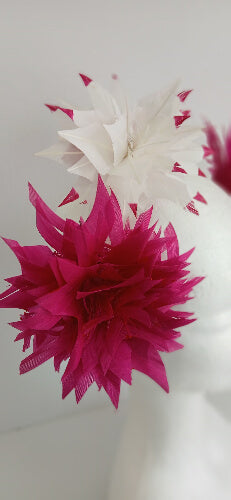 A picture of the pink and white feather flower headband by Melissa Rath Millinery.
