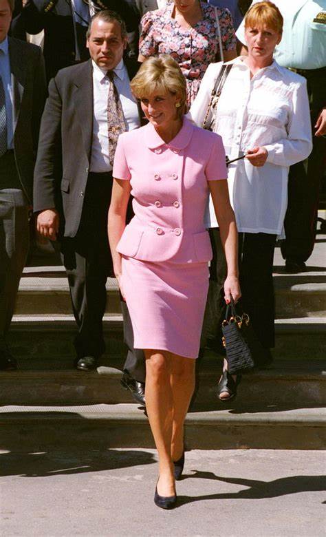 A picture of Princess Diana in a pink suit in 1996.