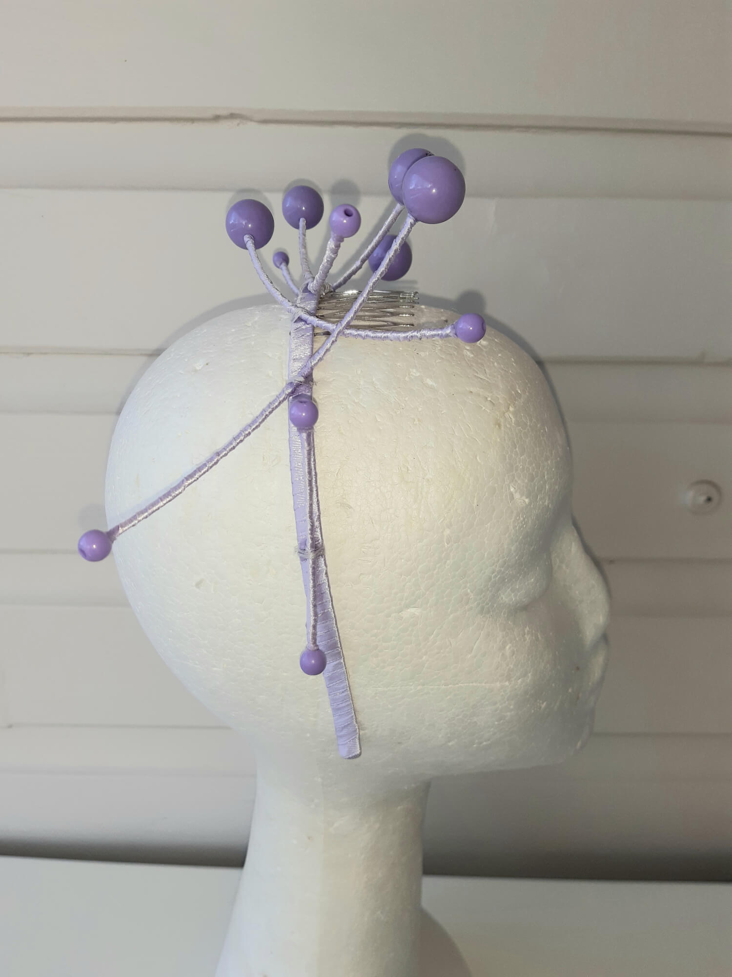 A picture of a purple beaded millinery headband by Melissa Rath Millinery.