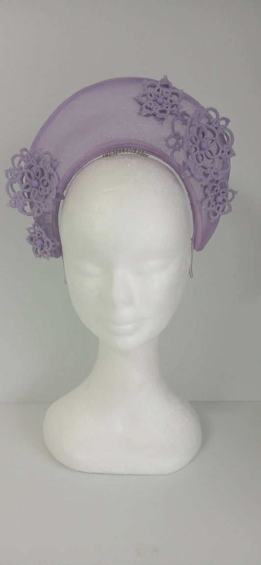 A lavender purple millinery crown by Melissa Rath Millinery, made from crinoline and trimmer with hand tatted flowers.