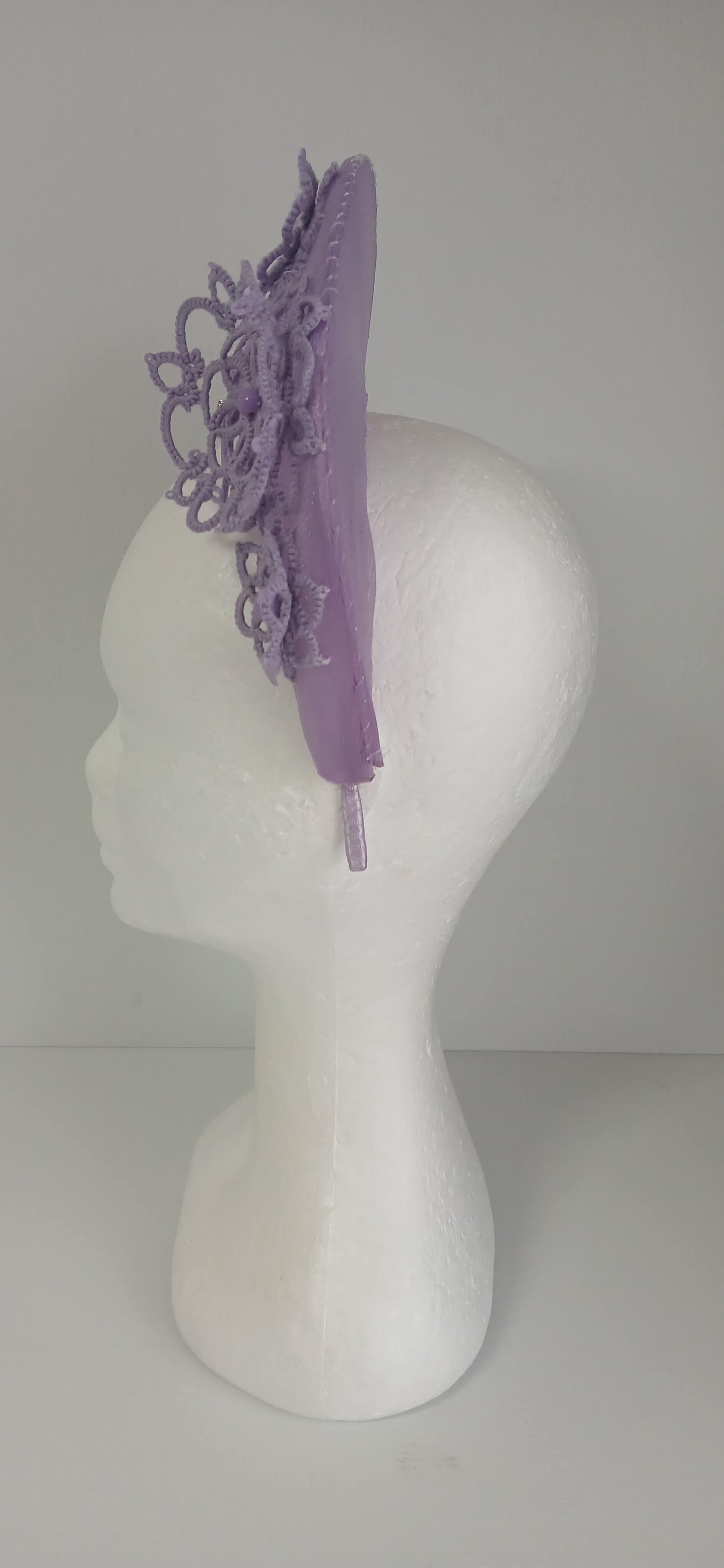 A lavender purple millinery crown by Melissa Rath Millinery, made from crinoline and trimmer with hand tatted flowers.