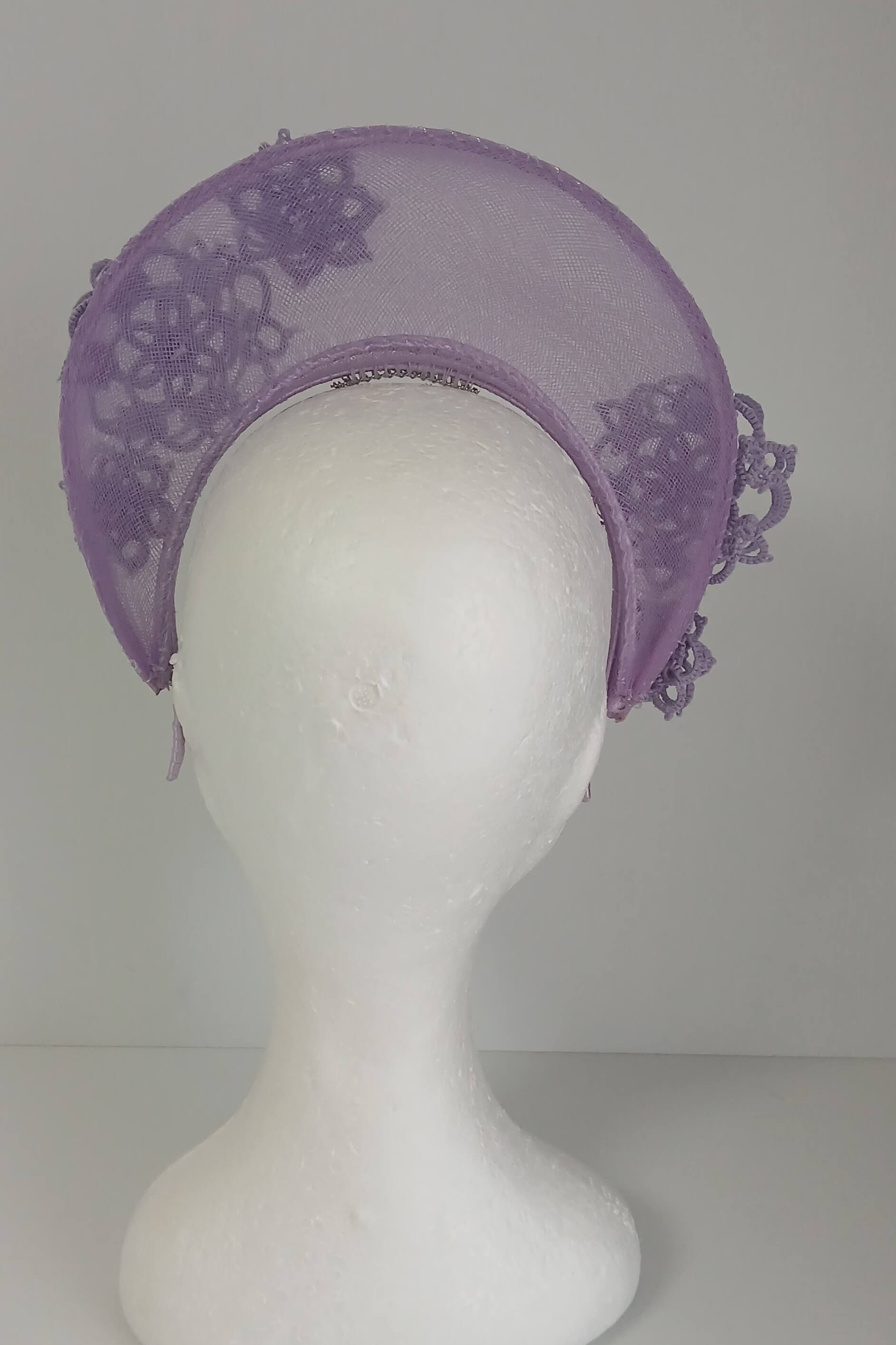 A lavender purple millinery crown by Melissa Rath Millinery, made from crinoline and trimmer with hand tatted flowers.