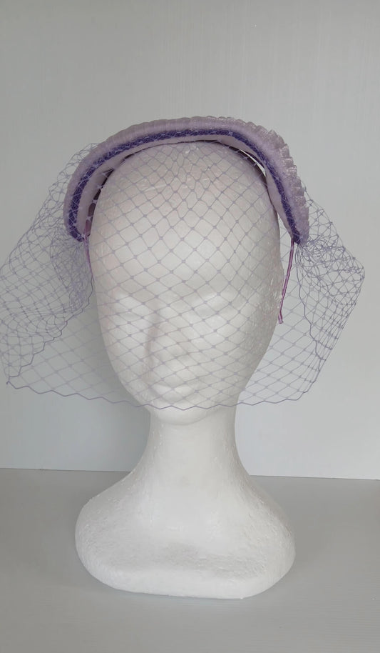 A picture of a Purple Veiled Pleated Organza Millinery Fascinator by Melissa Rath Millinery.