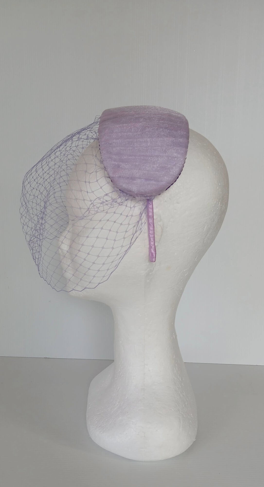 A picture of a Purple Veiled Pleated Organza Millinery Fascinator by Melissa Rath Millinery.