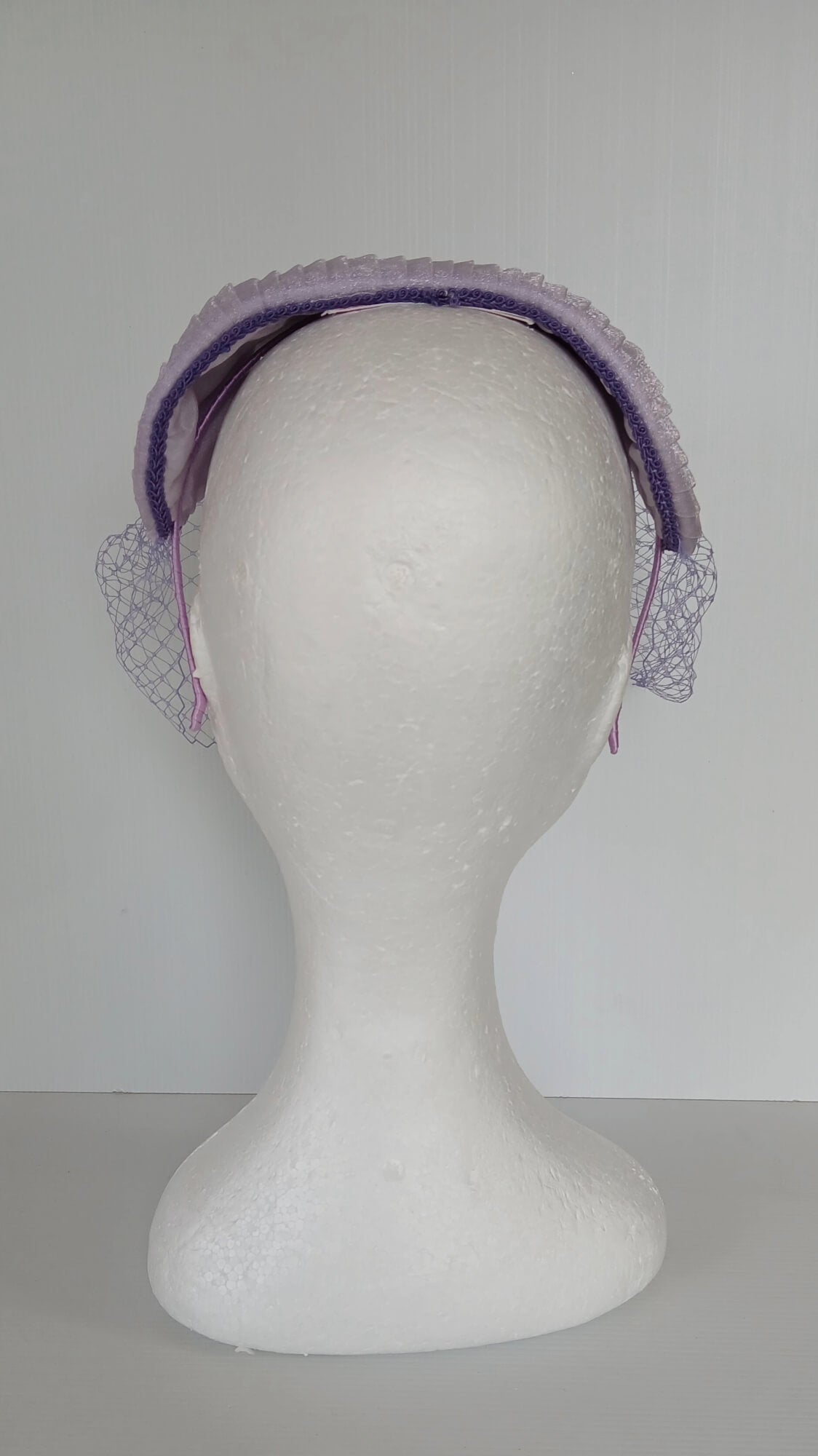 A picture of a Purple Veiled Pleated Organza Millinery Fascinator by Melissa Rath Millinery.