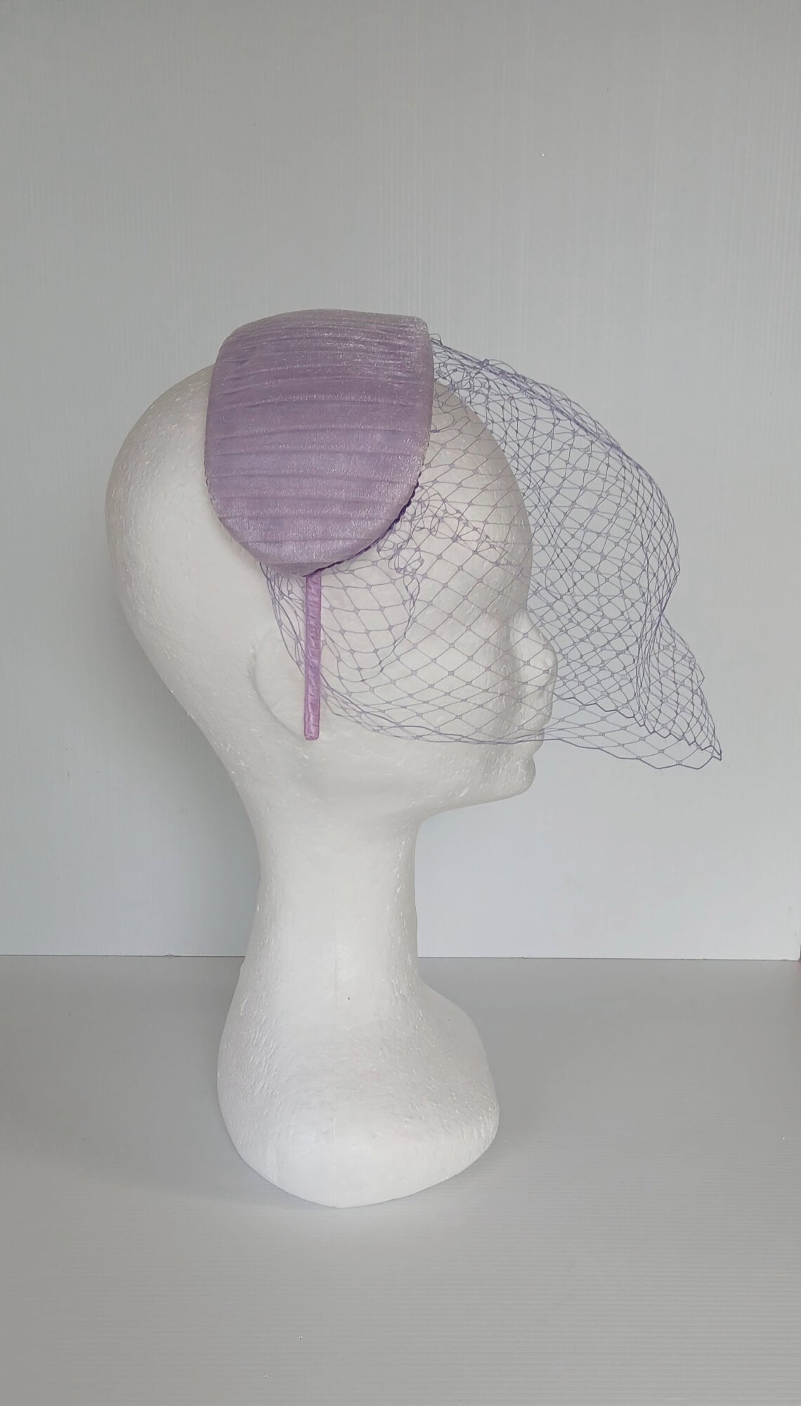 A picture of a Purple Veiled Pleated Organza Millinery Fascinator by Melissa Rath Millinery.