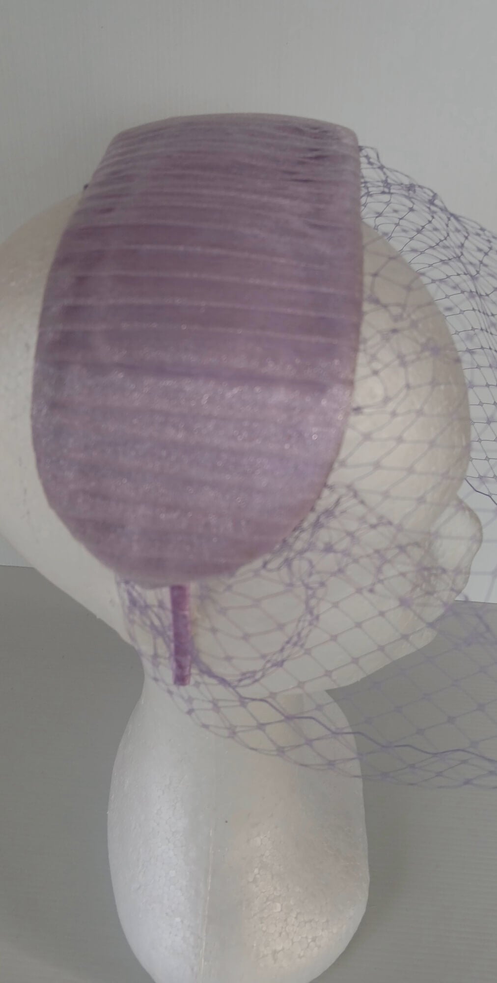 A picture of a Purple Veiled Pleated Organza Millinery Fascinator by Melissa Rath Millinery.