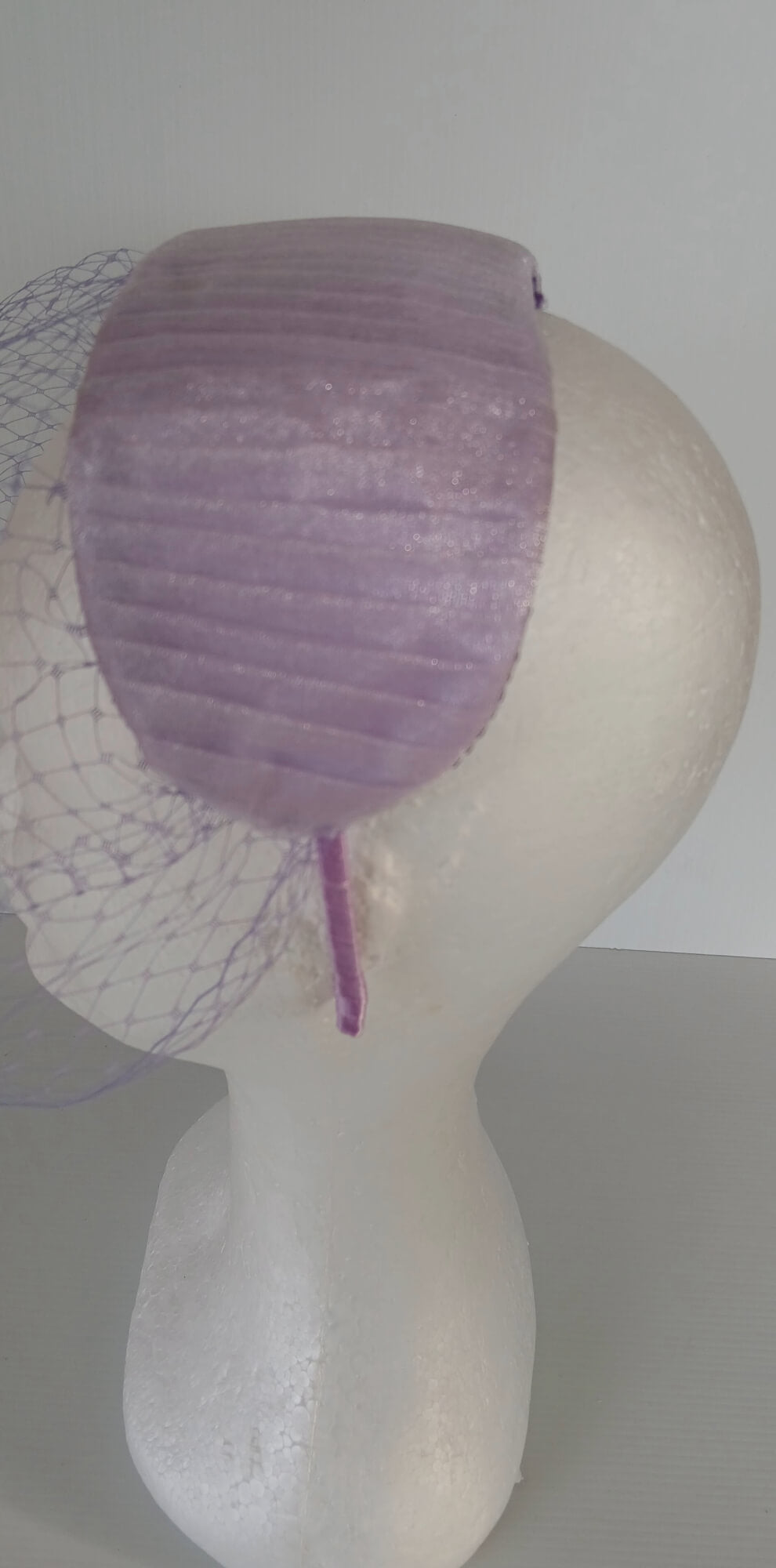 A picture of a Purple Veiled Pleated Organza Millinery Fascinator by Melissa Rath Millinery.