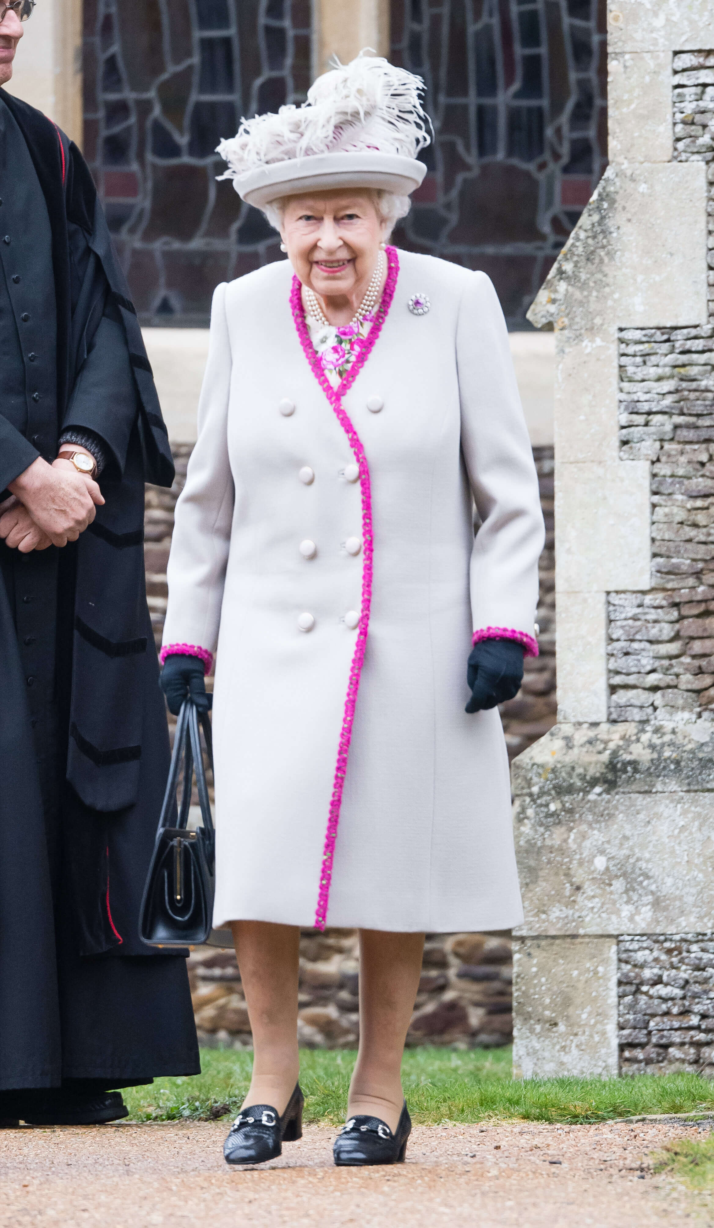 A picture of HRH Queen Elizabeth in a festive Christmas Day outfit.