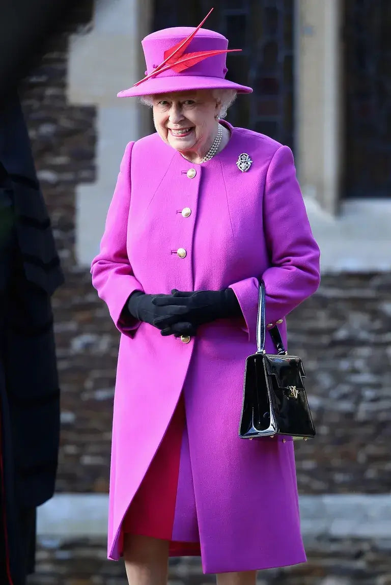 A picture of HRH Queen Elizabeth in a festive Christmas Day outfit.