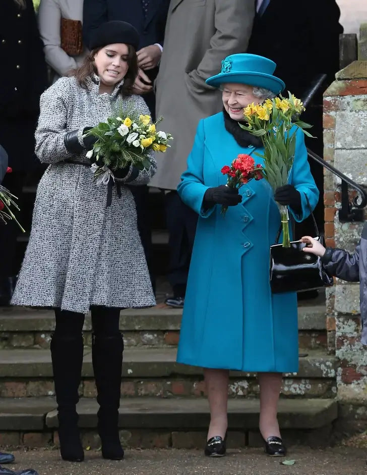 A picture of HRH Queen Elizabeth in a festive Christmas Day outfit.