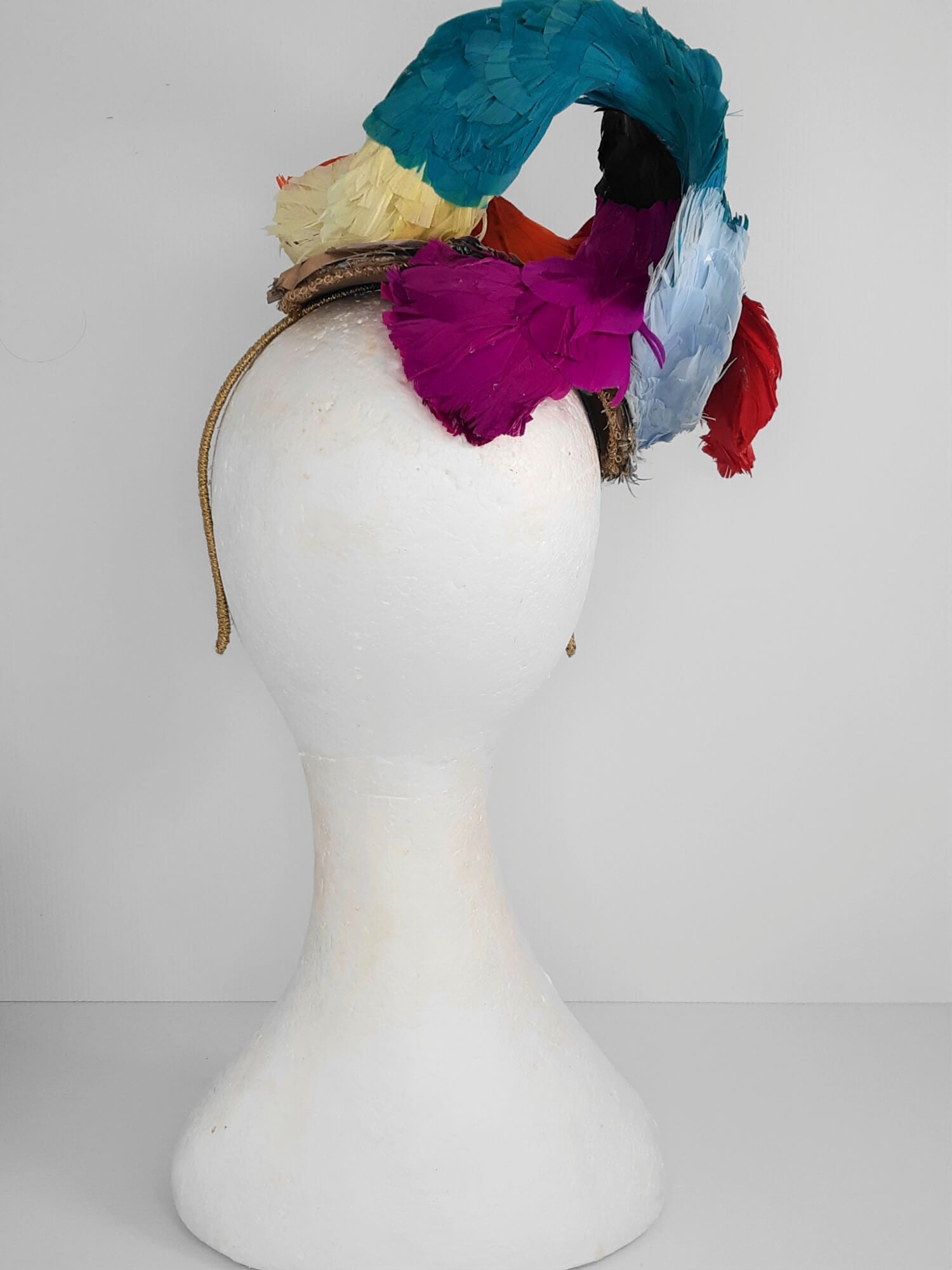 A picture of a Rainbow Feathered Millinery Fascinator by Melissa Rath Millinery.