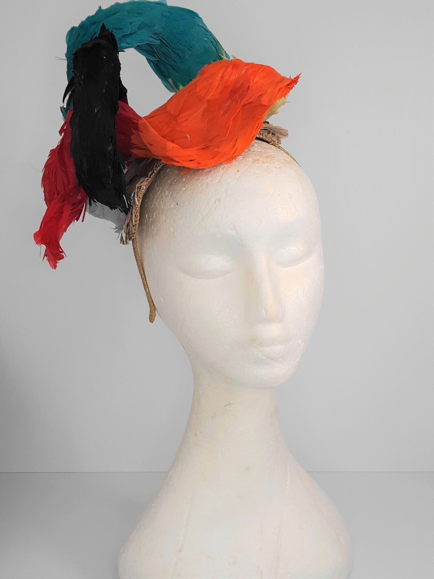 A picture of a Rainbow Feathered Millinery Fascinator by Melissa Rath Millinery.