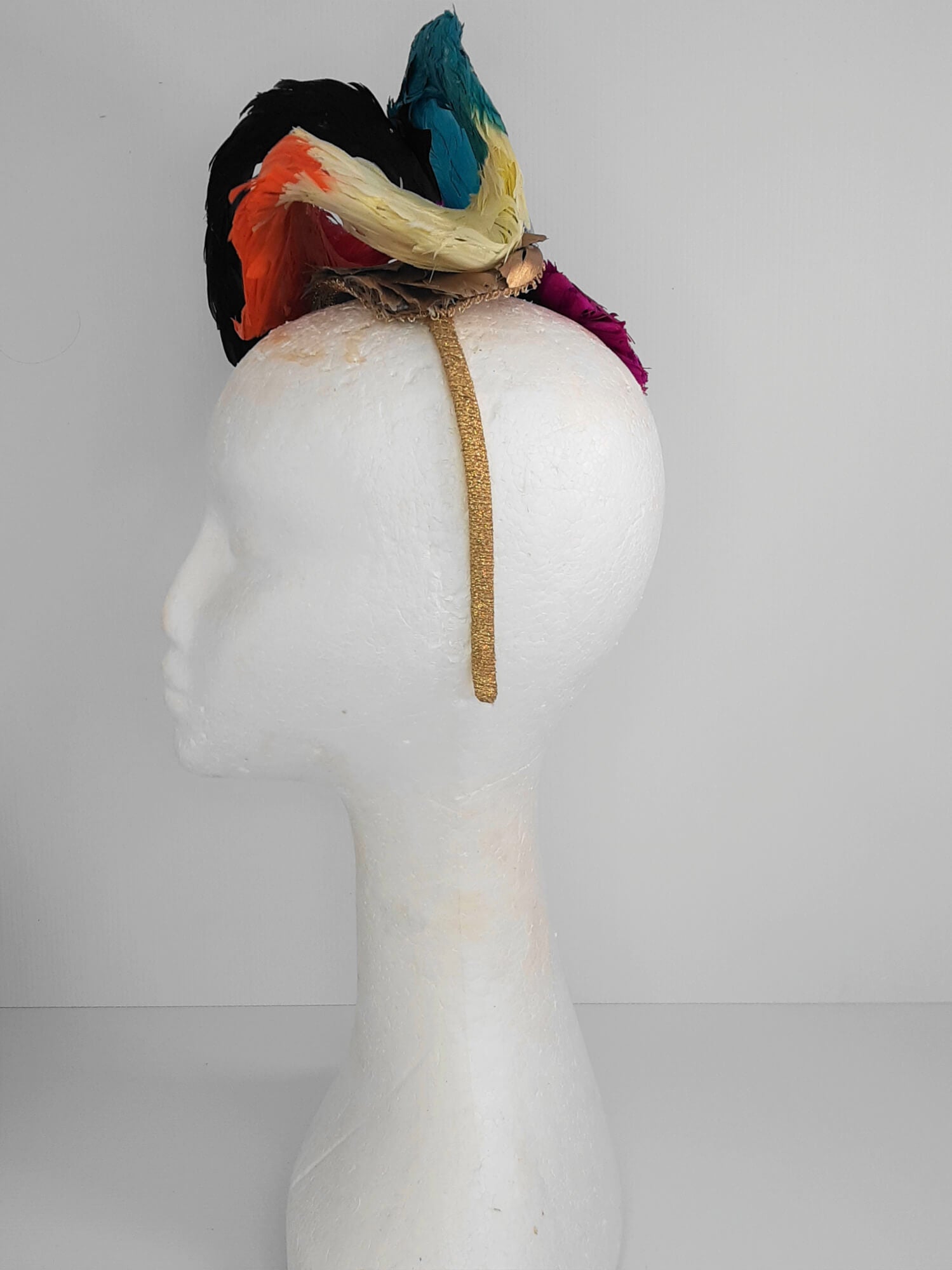 A picture of a Rainbow Feathered Millinery Fascinator by Melissa Rath Millinery.