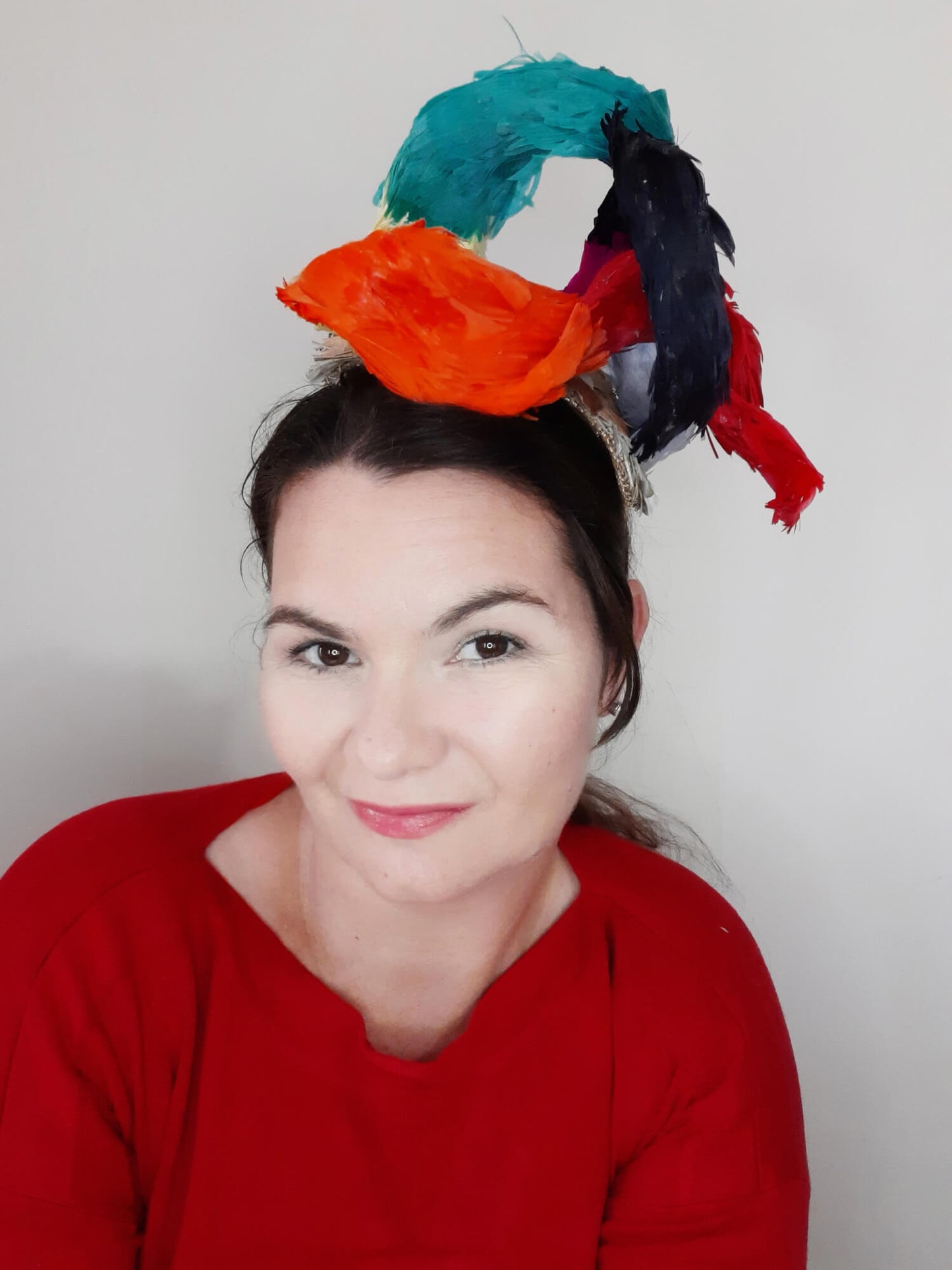 A picture of a Rainbow Feathered Millinery Fascinator by Melissa Rath Millinery.