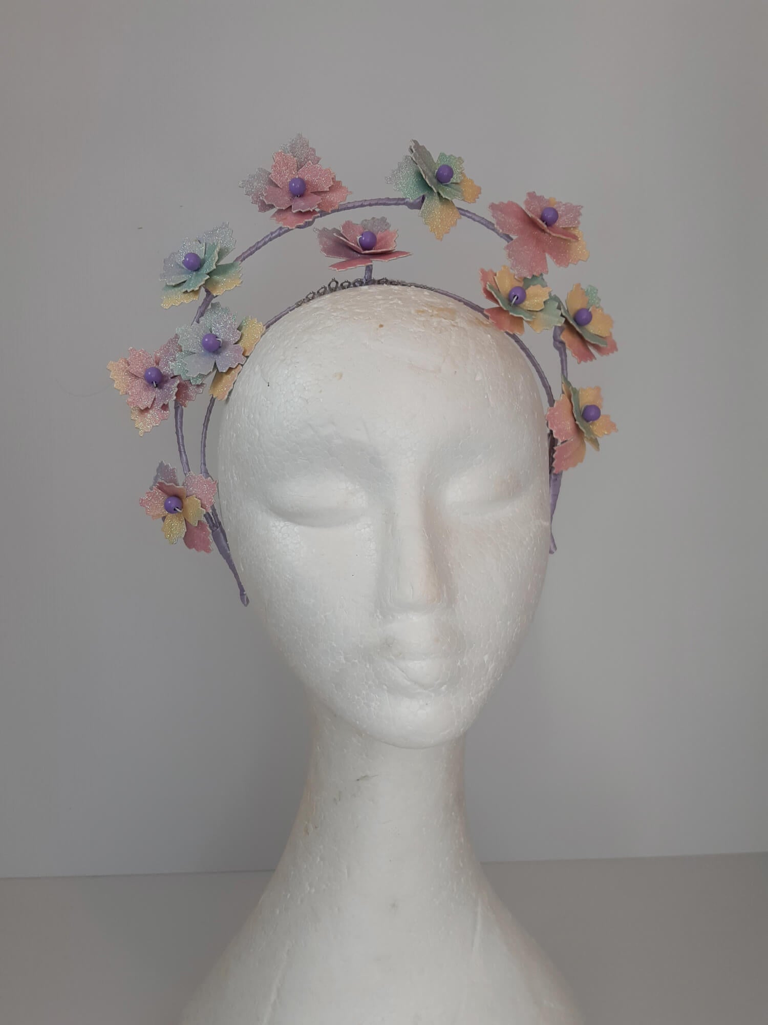 A picture of a rainbow millinery halo crown by Melissa Rath Millinery.