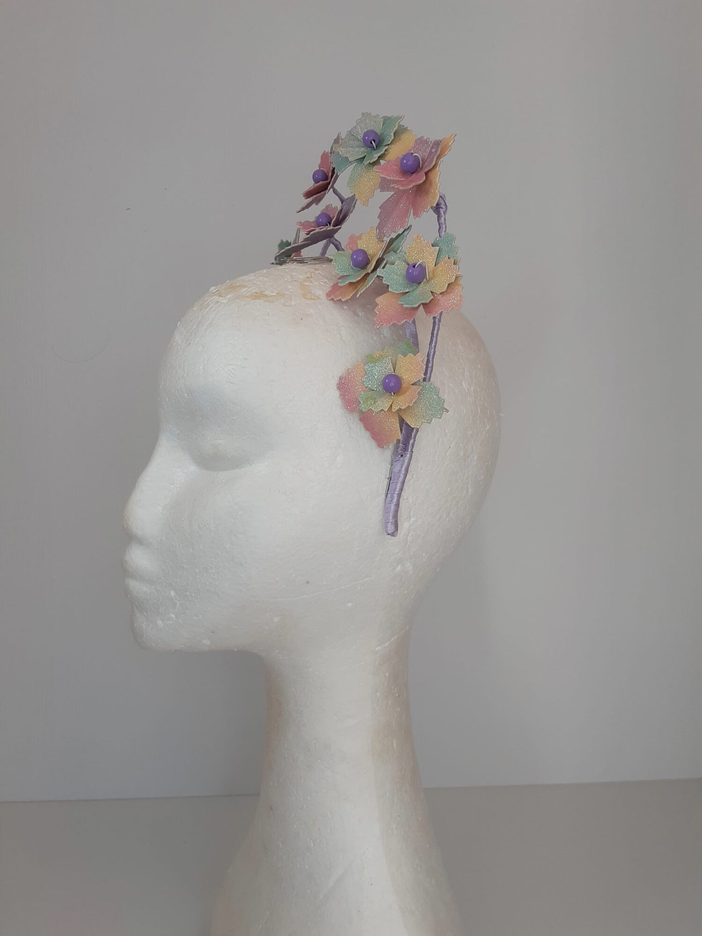 A picture of a rainbow millinery halo crown by Melissa Rath Millinery.