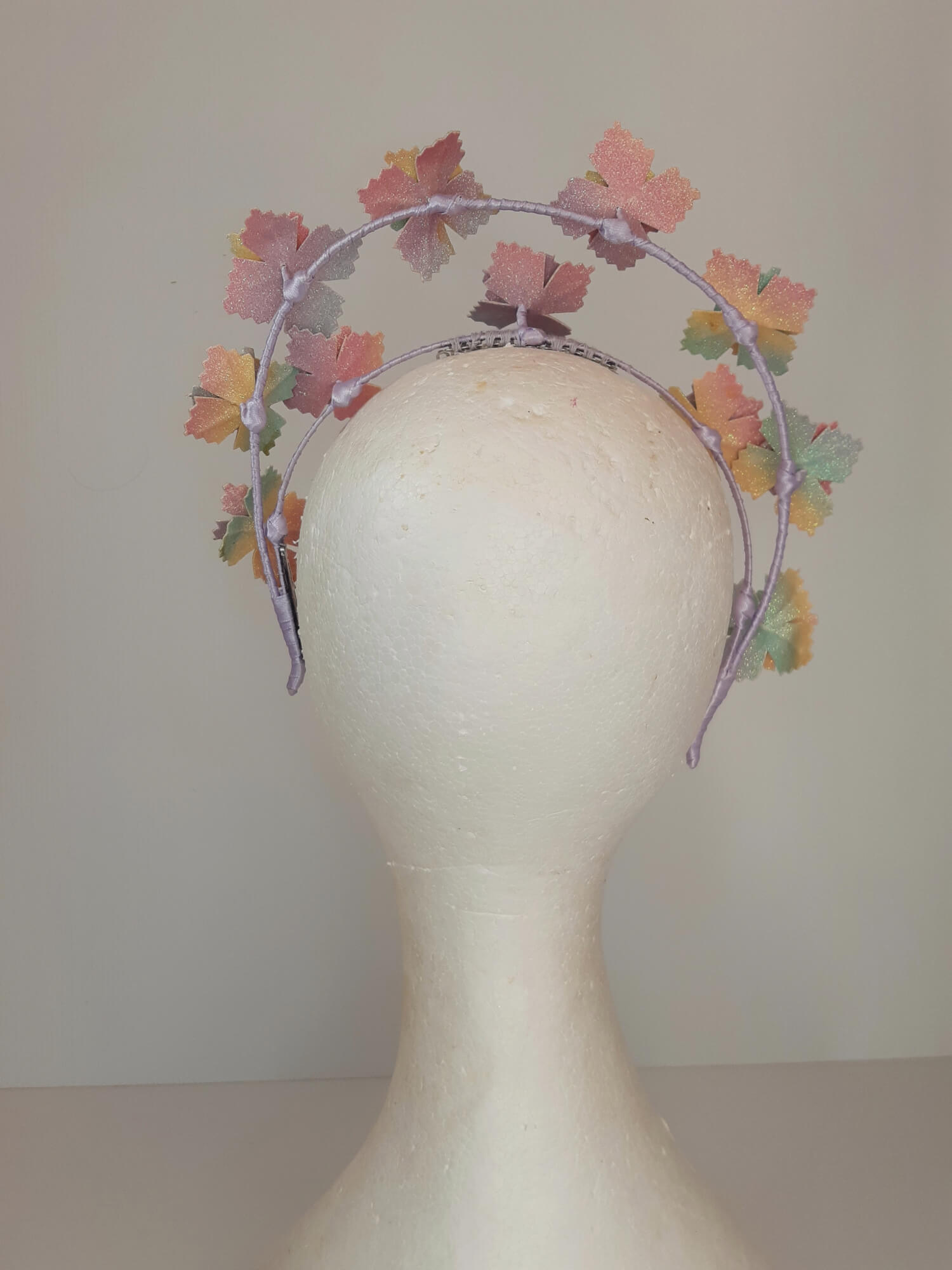 A picture of a rainbow millinery halo crown by Melissa Rath Millinery.