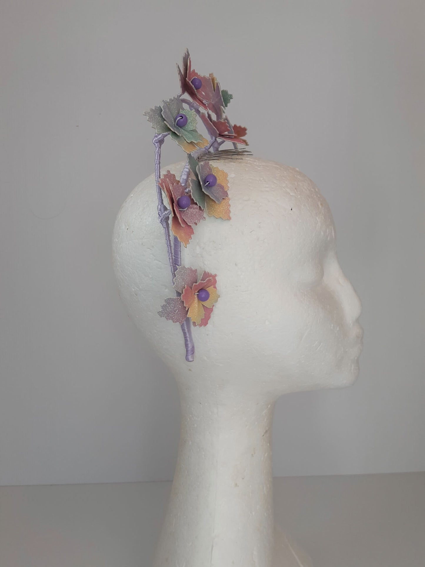 A picture of a rainbow millinery halo crown by Melissa Rath Millinery.