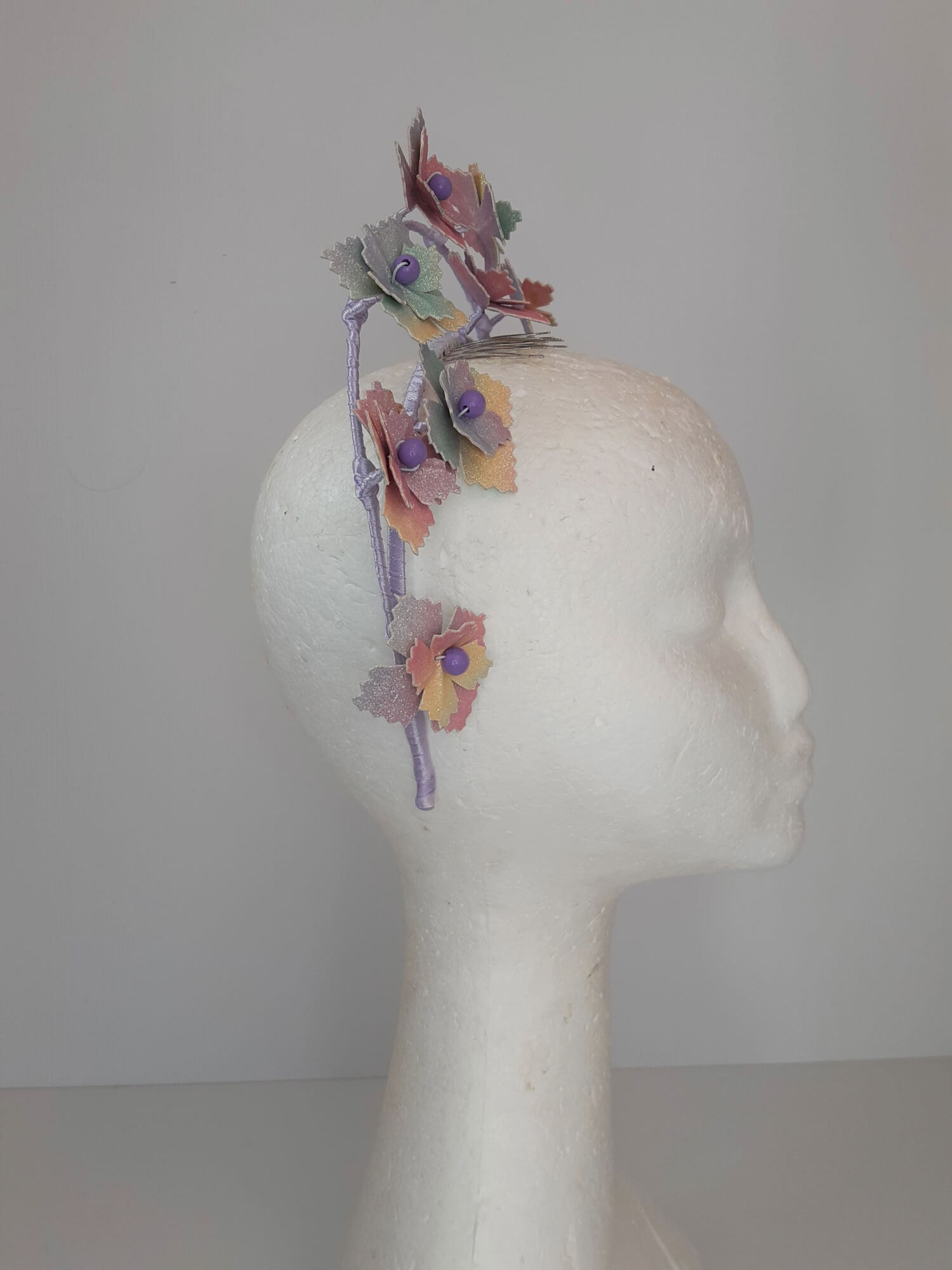 A picture of a rainbow millinery halo crown by Melissa Rath Millinery.