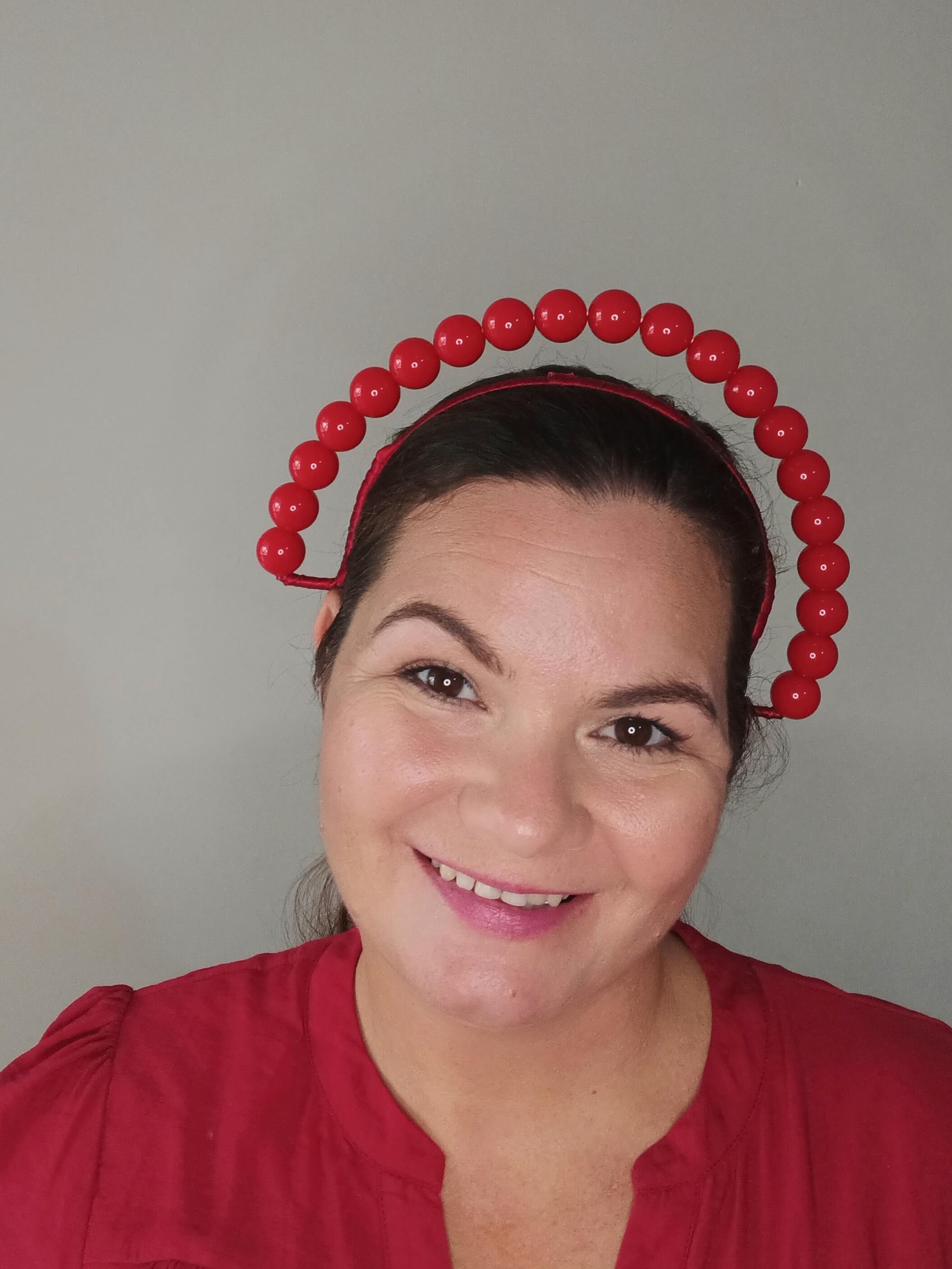 A picture of a Red Beaded Headband by Melissa Rath  Millinery