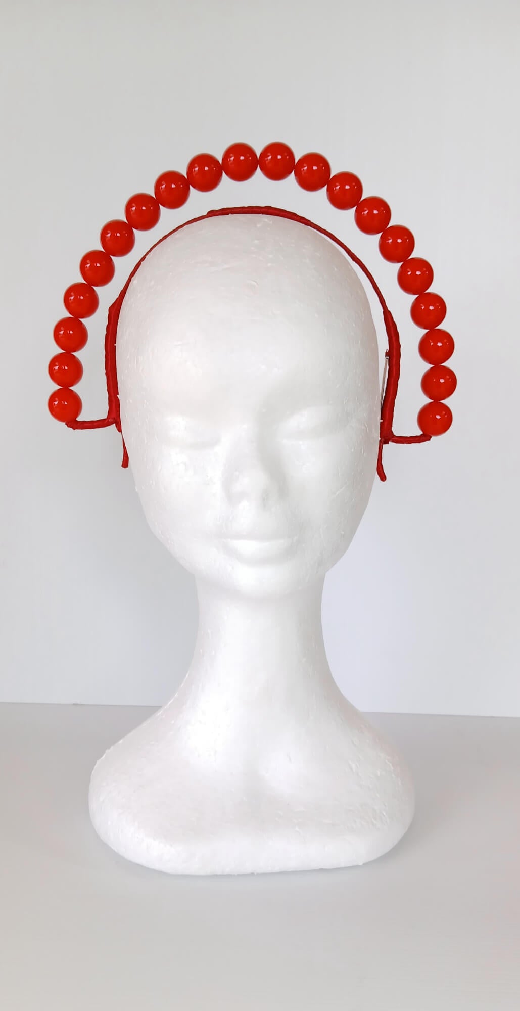 A picture of a Red Beaded Headband by Melissa Rath  Millinery.